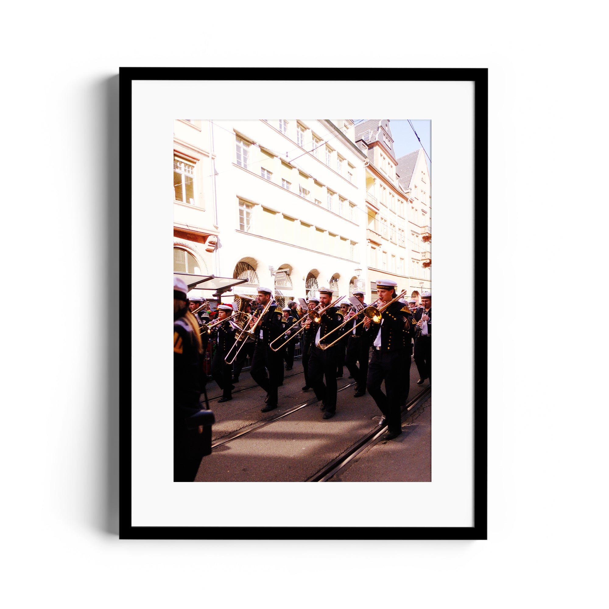 Framed fine art photo of a marching band with trombones, showcasing dynamic street performance.