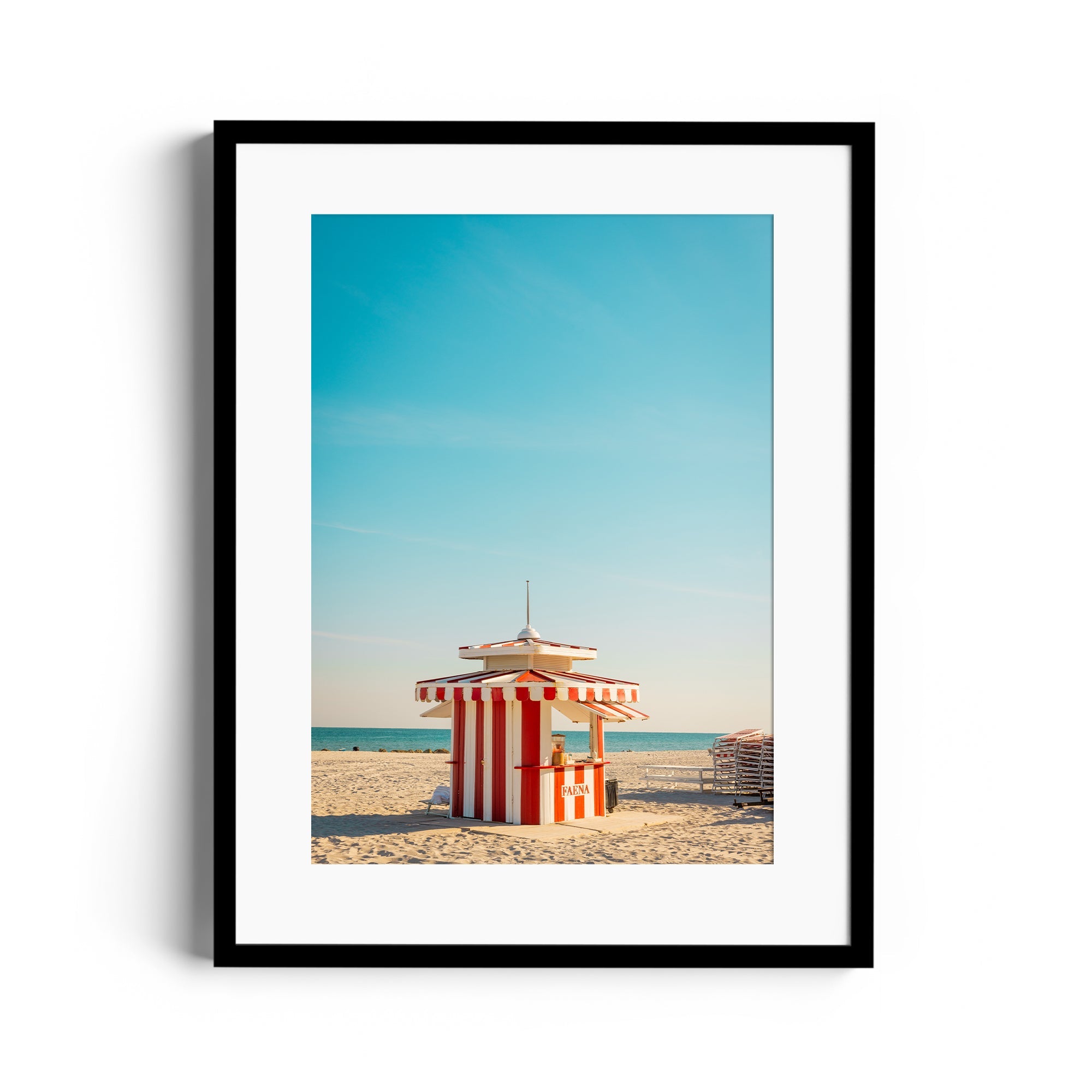 Framed fine art photograph of a red and white striped beach hut on Miami's sunny beach, showcasing its vibrant character.