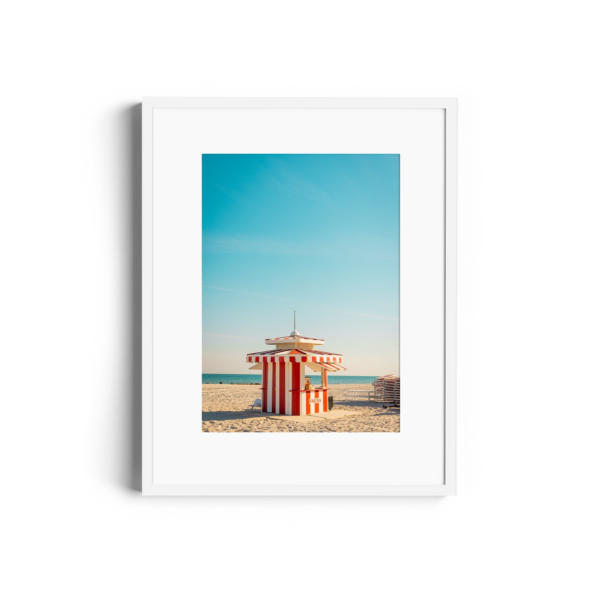 Framed fine art photograph of a striped lifeguard tower on Miami beach, showcasing vibrant colors and Art Deco influences.
