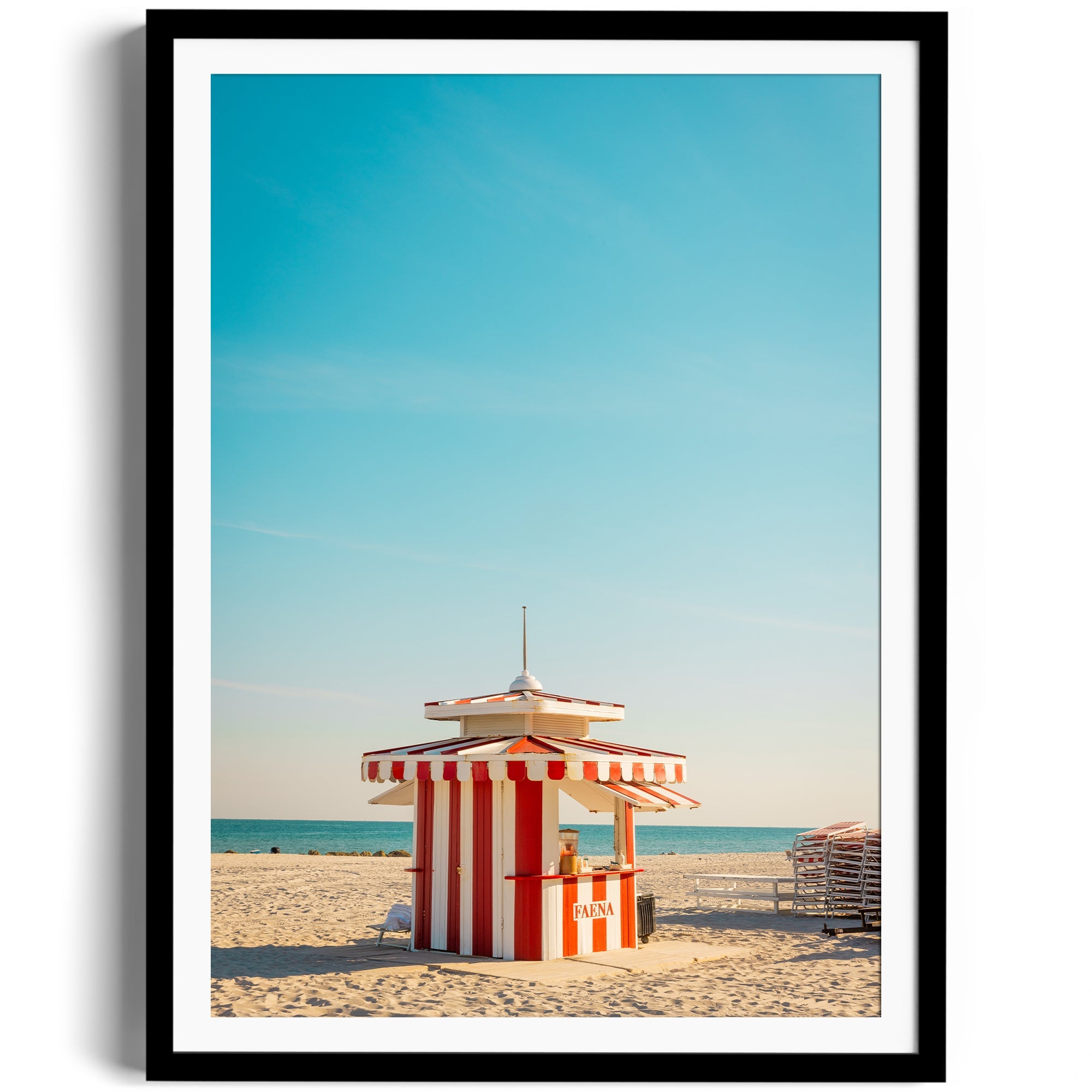 Framed fine art photograph of a red and white lifeguard hut on Miami beach under a clear blue sky.