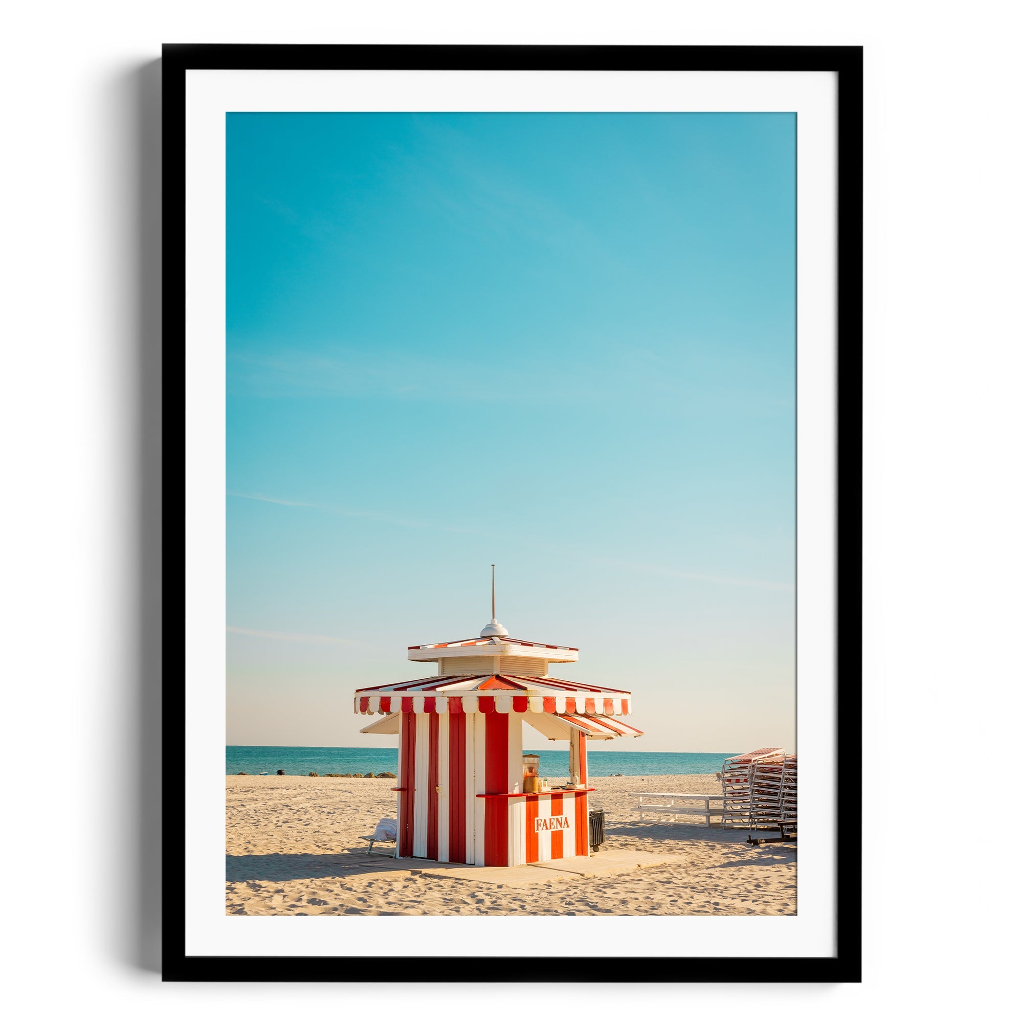 Framed fine art photograph of a classic striped beach hut in Miami, Florida, under a clear blue sky.