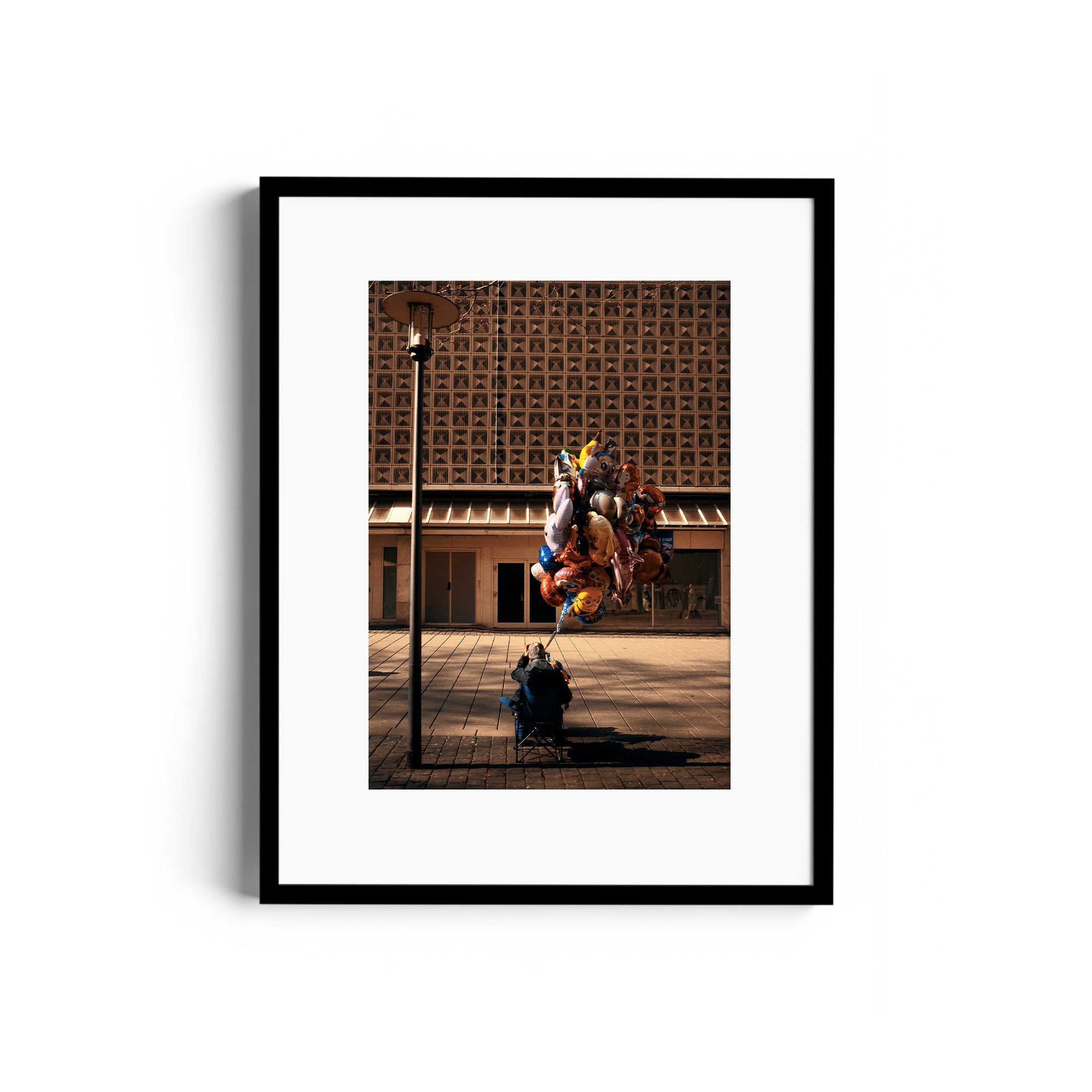 Framed fine art photograph titled 'UP' by Marcelo Cadavid, showcasing colorful balloons in an urban setting.