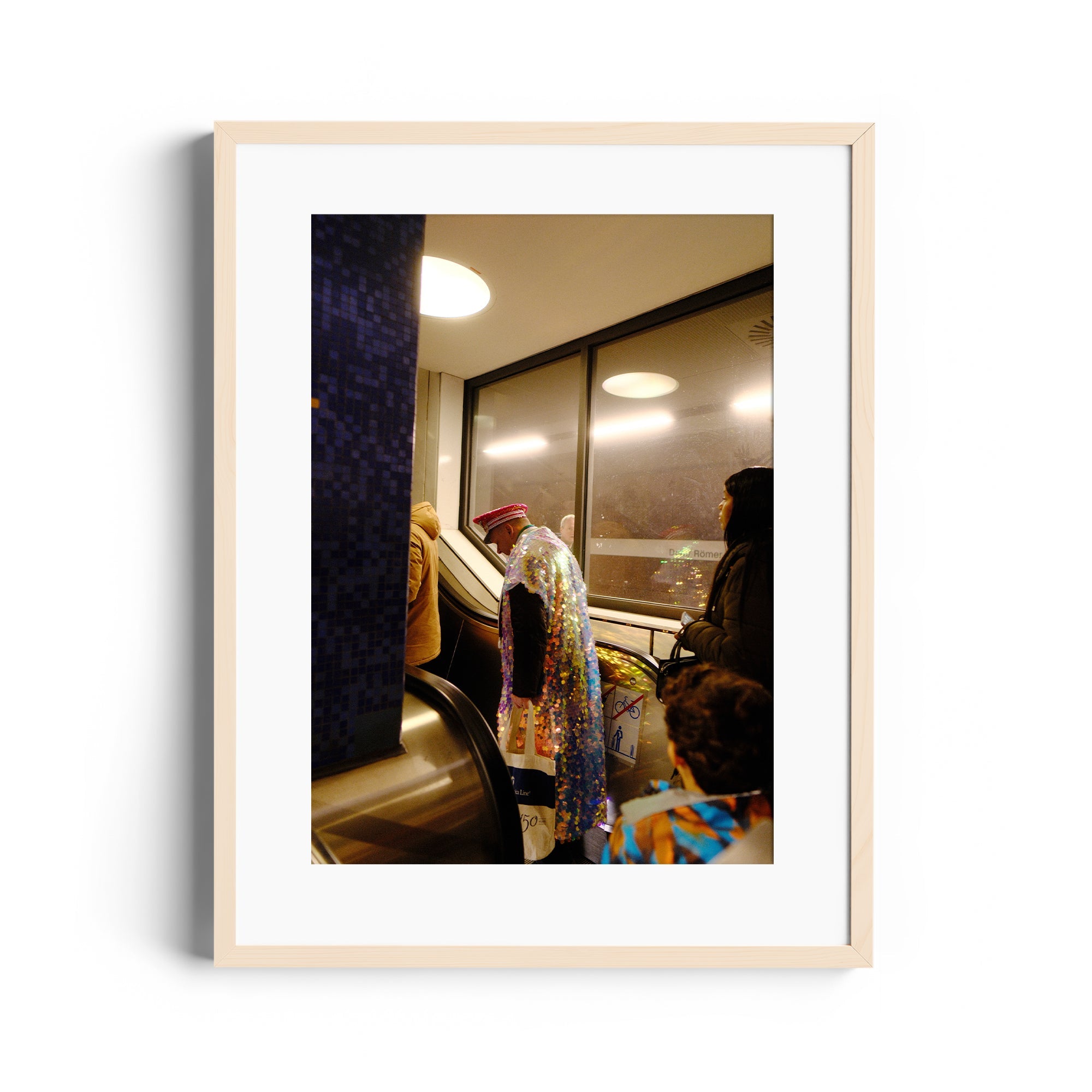 Framed fine art photograph depicting colorful figures on an escalator, highlighting the elegance of everyday life.