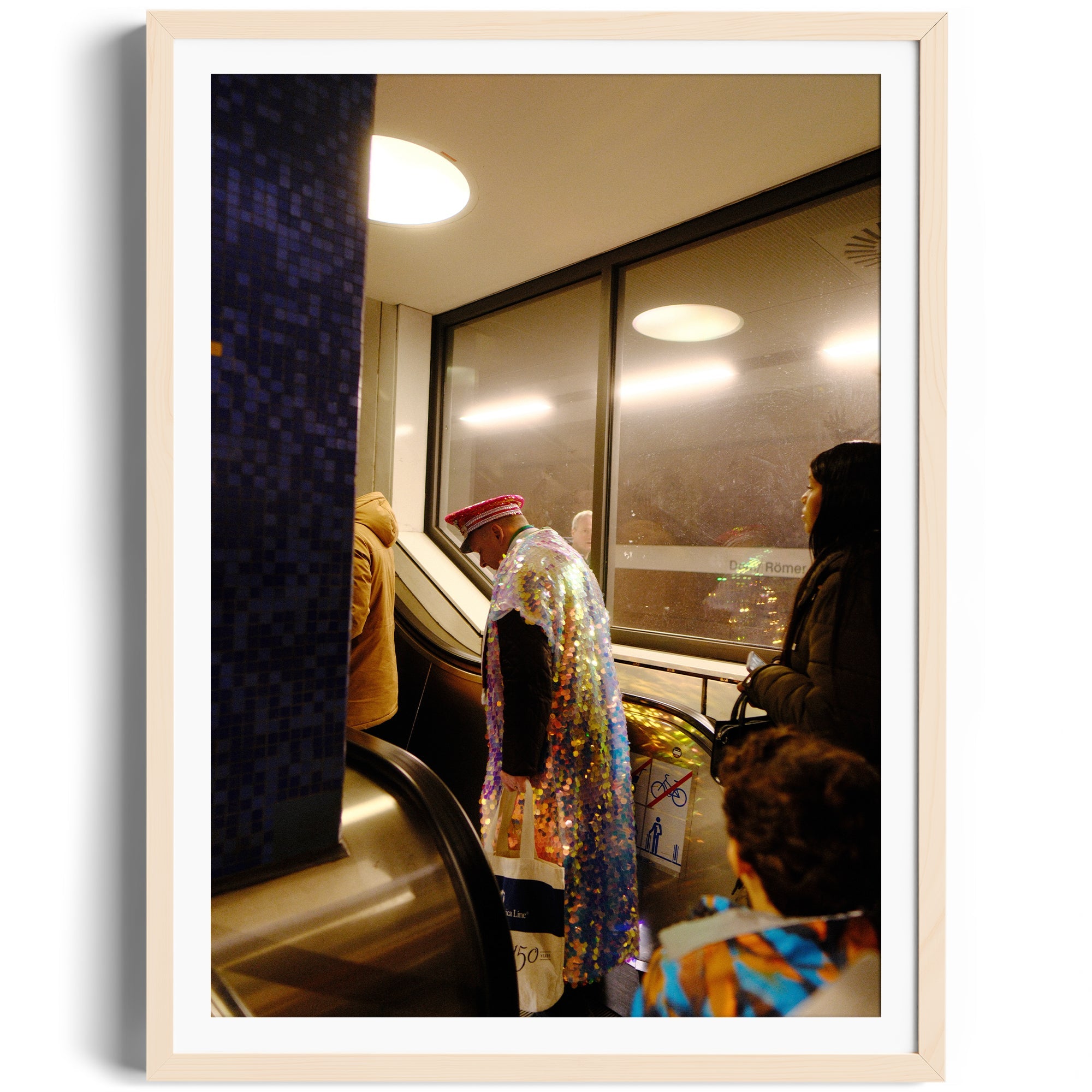 A woman in a colorful outfit stands on an escalator, capturing a candid urban moment in fine art photography.