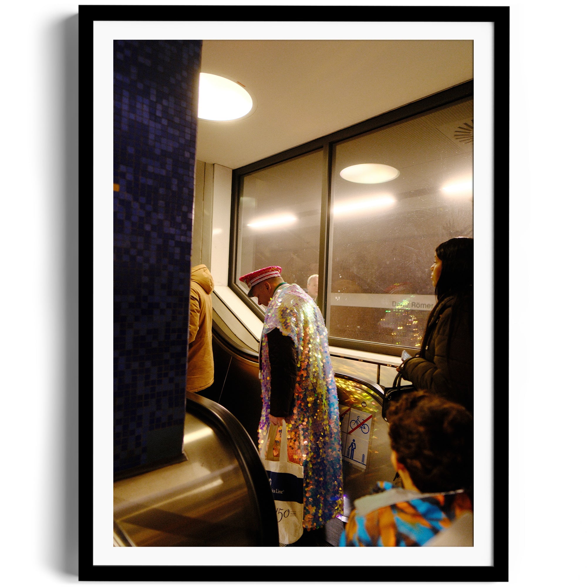 Framed photograph of individuals on an escalator, showcasing vibrant fashion and urban life.
