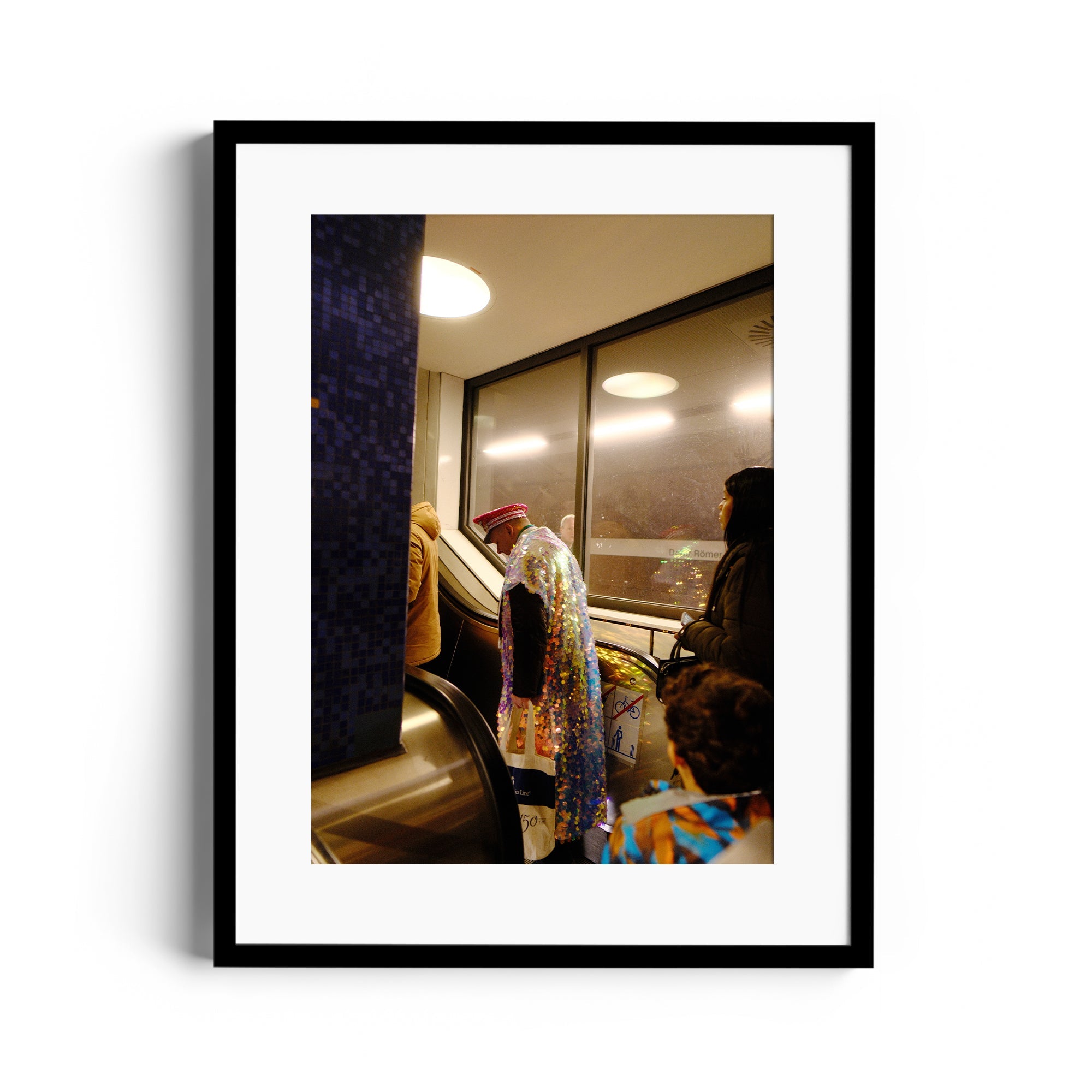 Framed fine art photograph by Marcelo Cadavid, depicting a vibrant scene in a public transport setting.