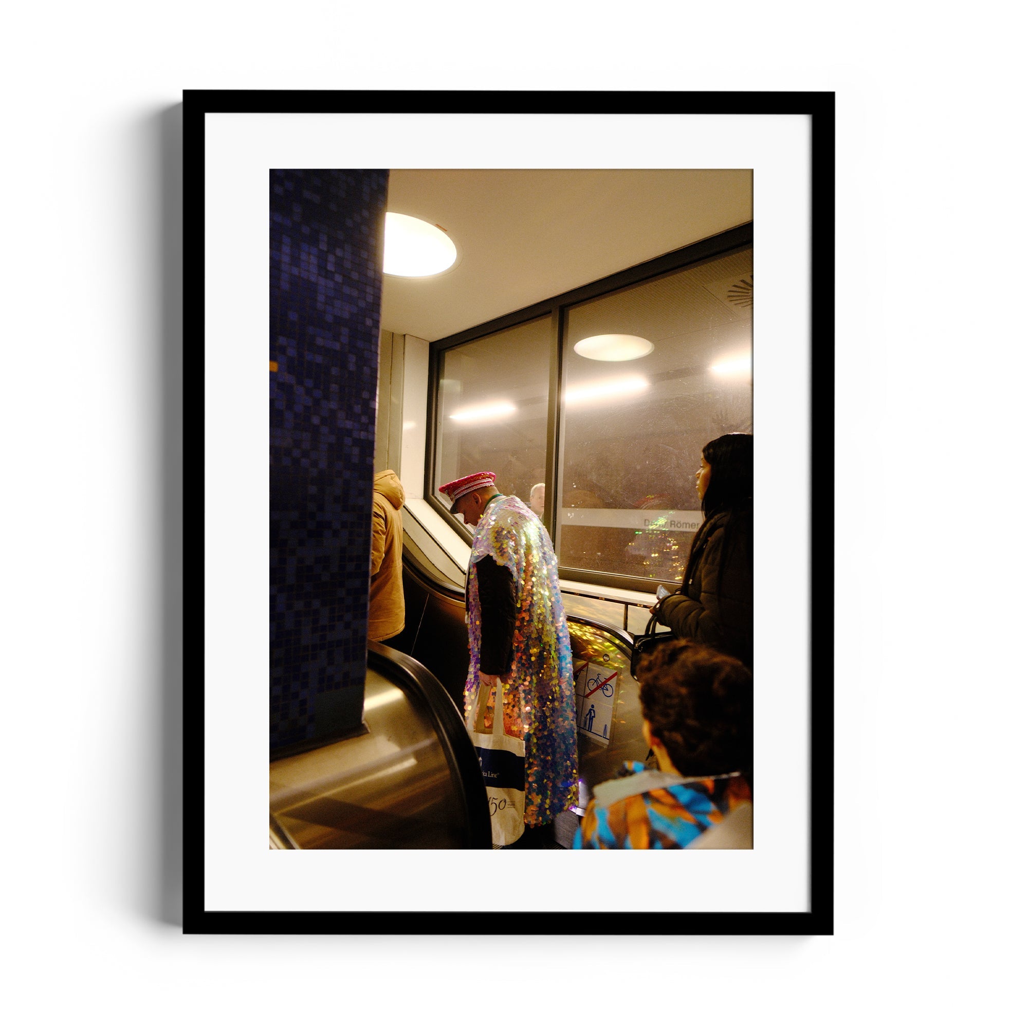 Framed fine art photo of individuals on an escalator, capturing candid urban moments and diverse styles.