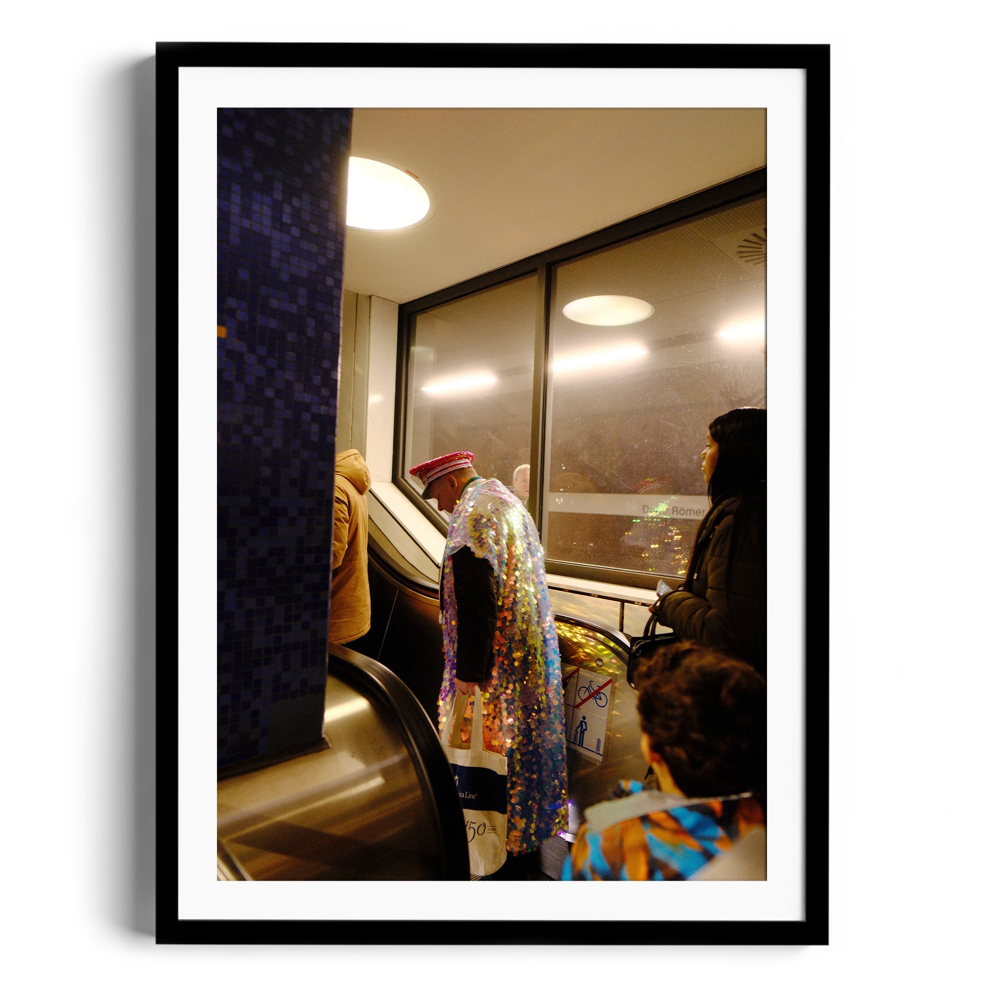 Framed fine art photograph capturing a colorful figure on an escalator, blending urban life and artistic expression.