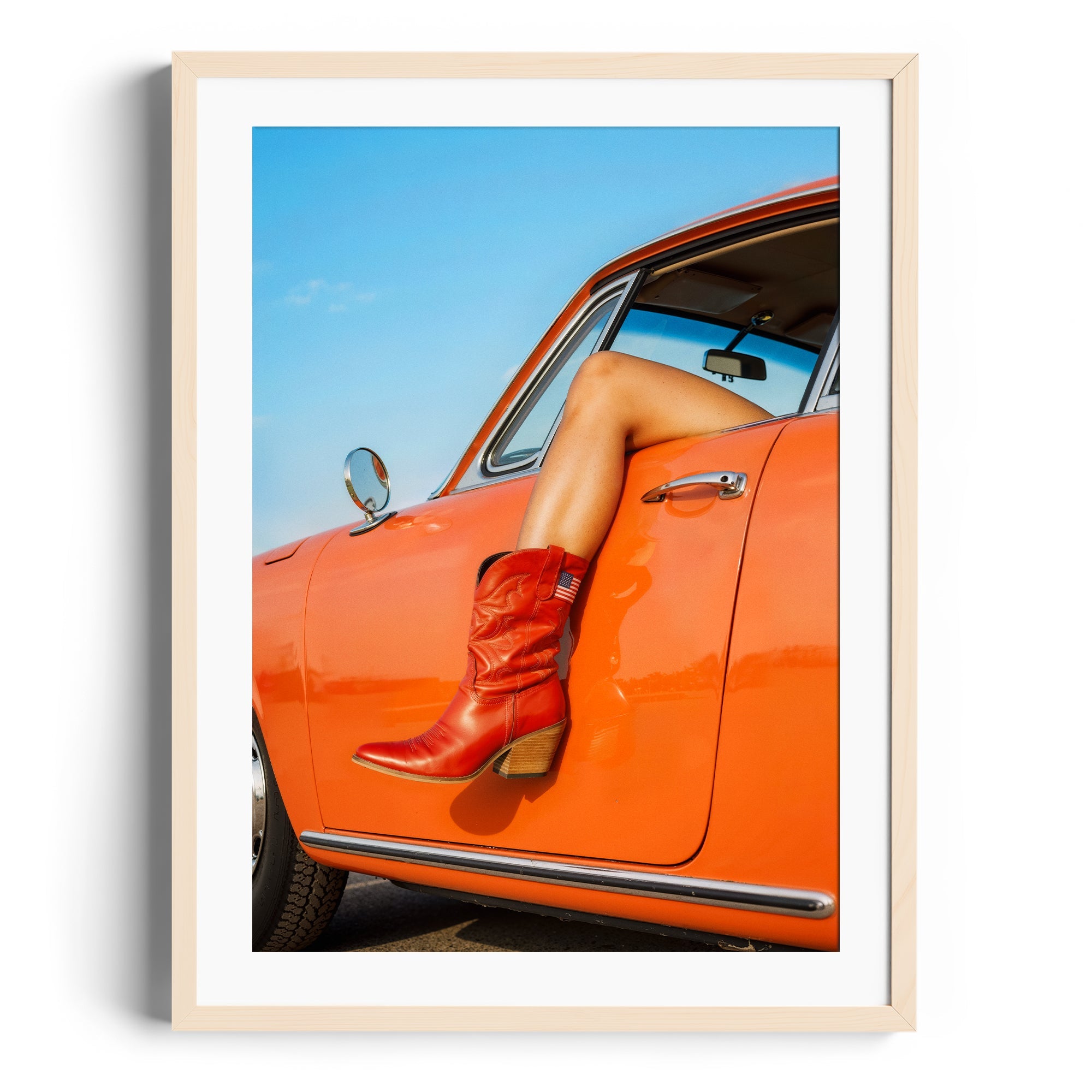 Red cowgirl boots showcased on a car door, framed fine art print by Diego Cadavid Mora, perfect for gallery display in Miami.