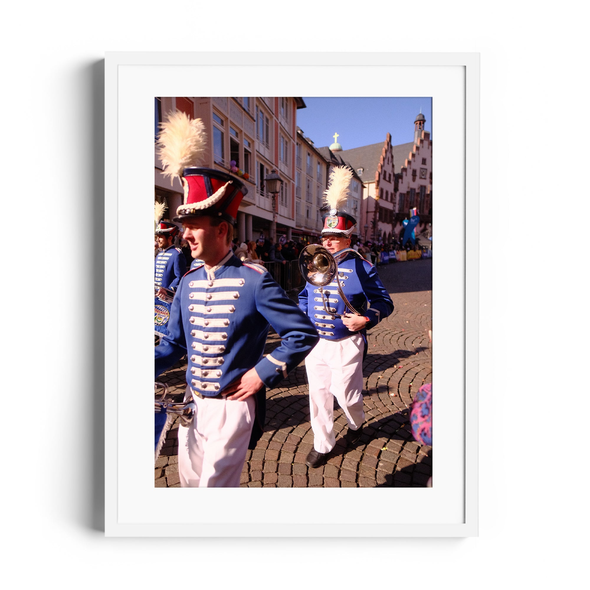 A marching band in vibrant uniforms performing in a historic street, framed fine art photography by Marcelo Cadavid.