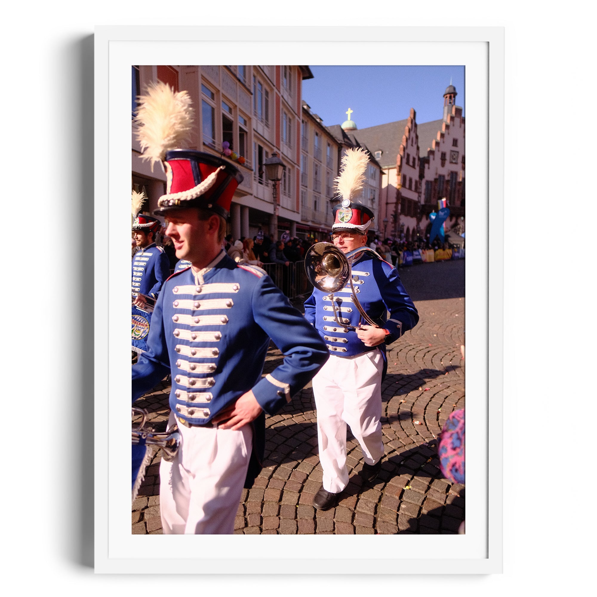Marching band members in uniform parade past historic buildings, framed fine art photography by Marcelo Cadavid.