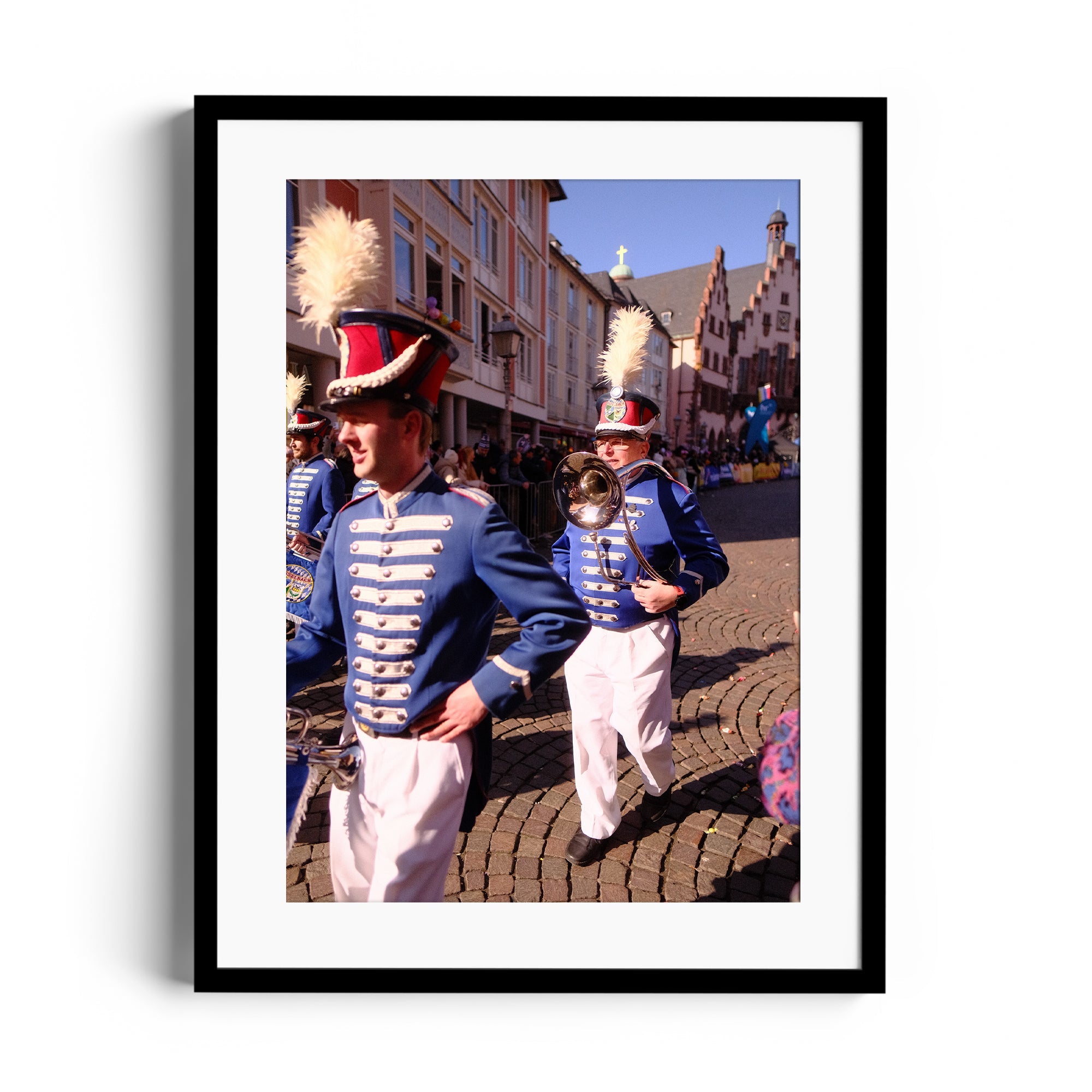 Marching band members in colorful uniforms performing in a historic street setting, captured in fine art photography.