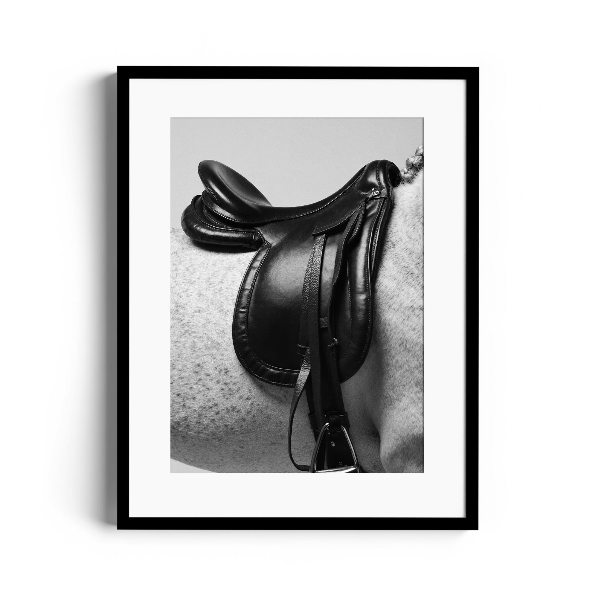Black and white fine art print of an English saddle on a dappled grey horse, showcasing equestrian elegance, Miami gallery.