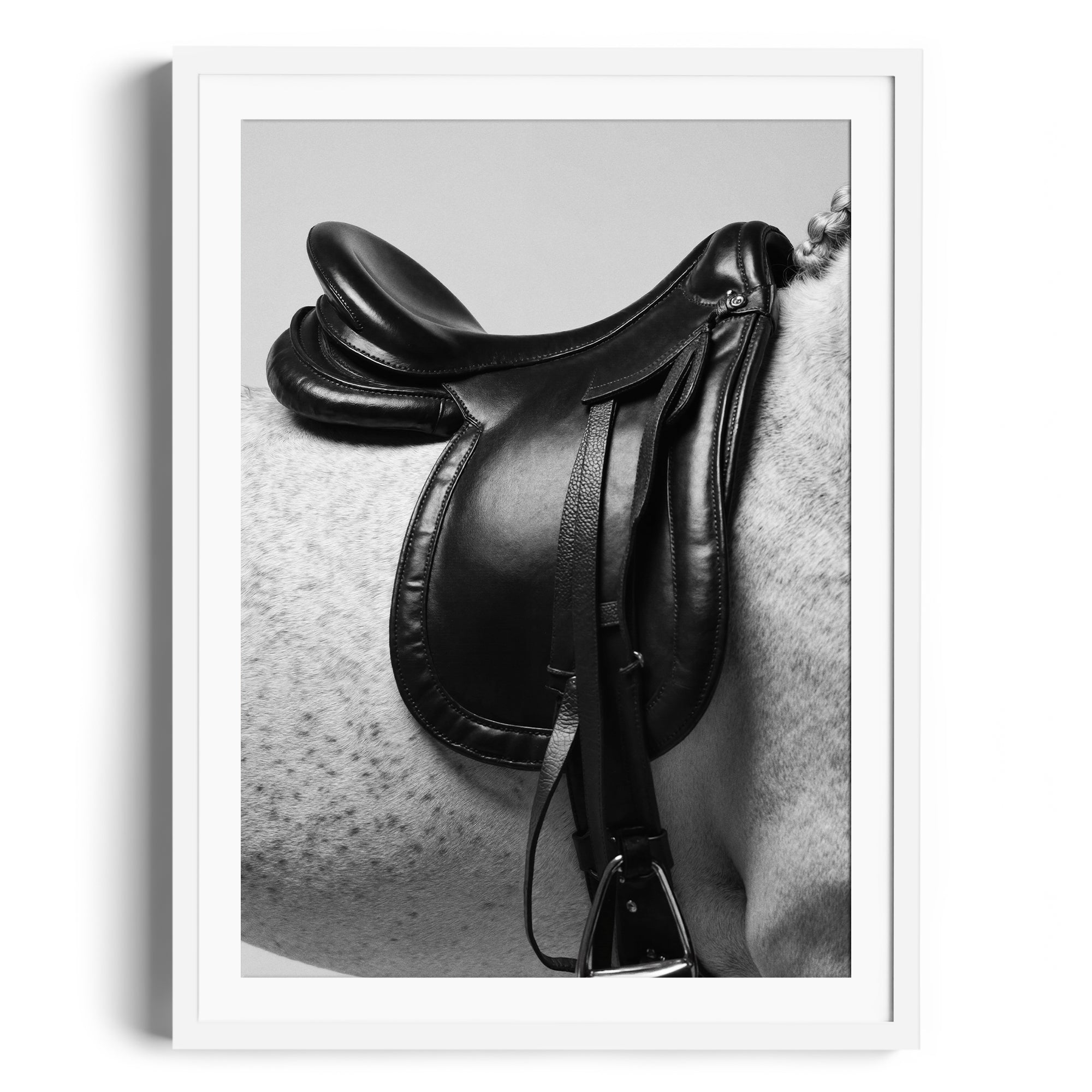 Monochrome fine art of an English saddle on a dappled grey horse, showcasing equestrian elegance in a Miami gallery.