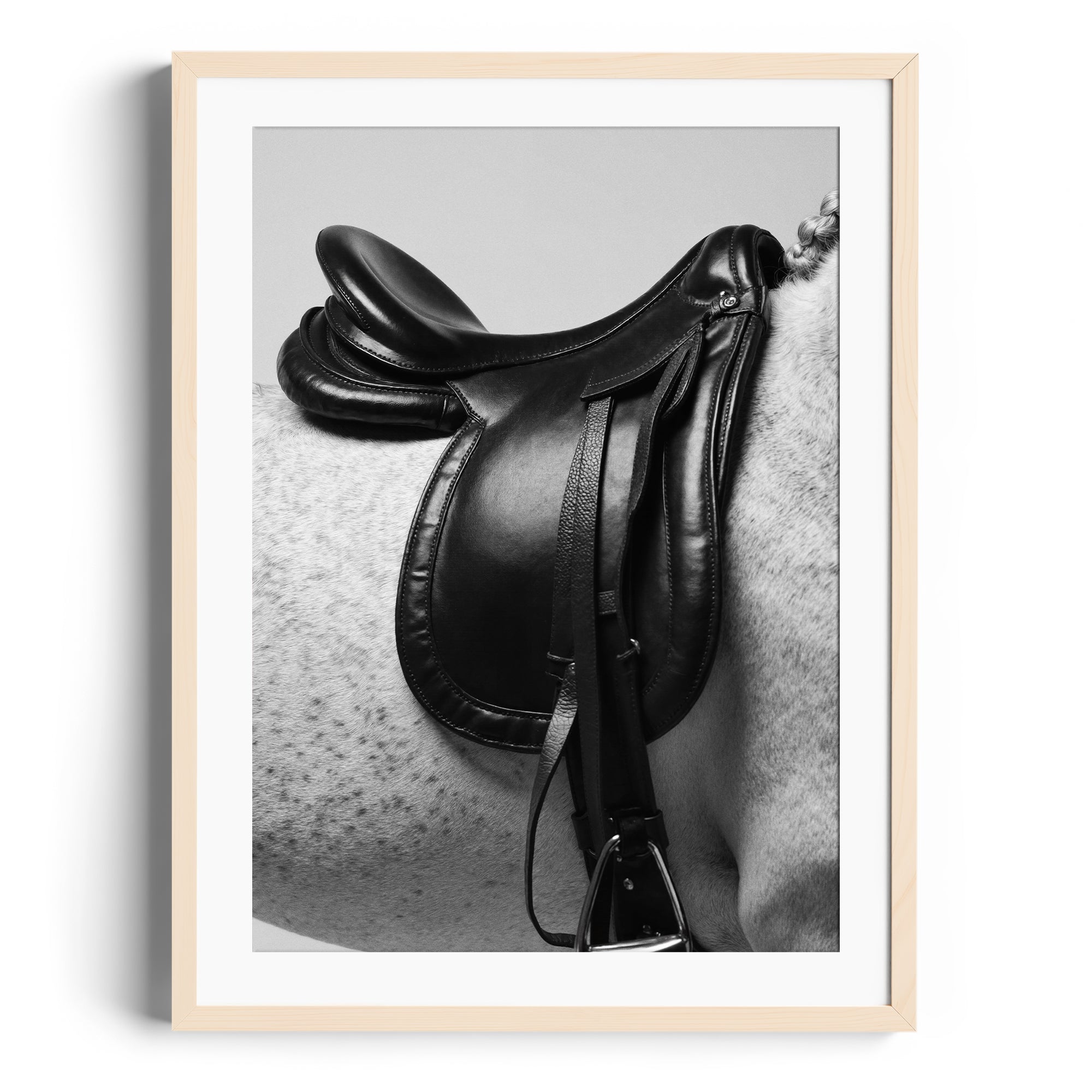Limited edition fine art print of a black saddle on a dappled grey horse, showcasing equestrian elegance and craftsmanship.