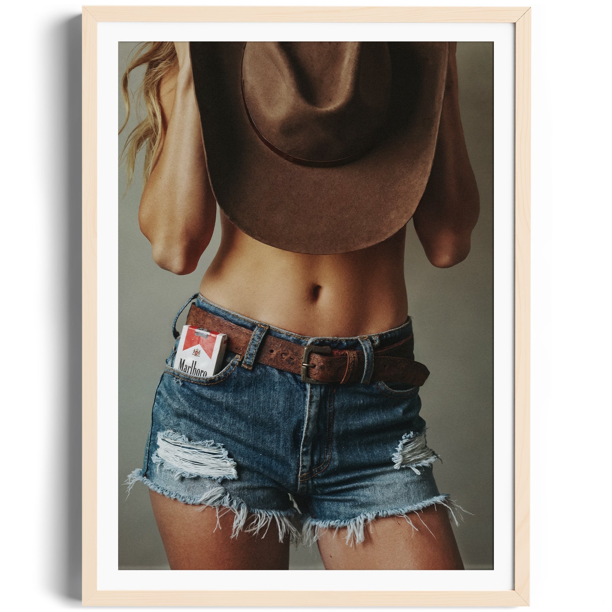 Limited edition fine art photography showcasing distressed denim and cowboy hat, capturing raw independence in Miami.