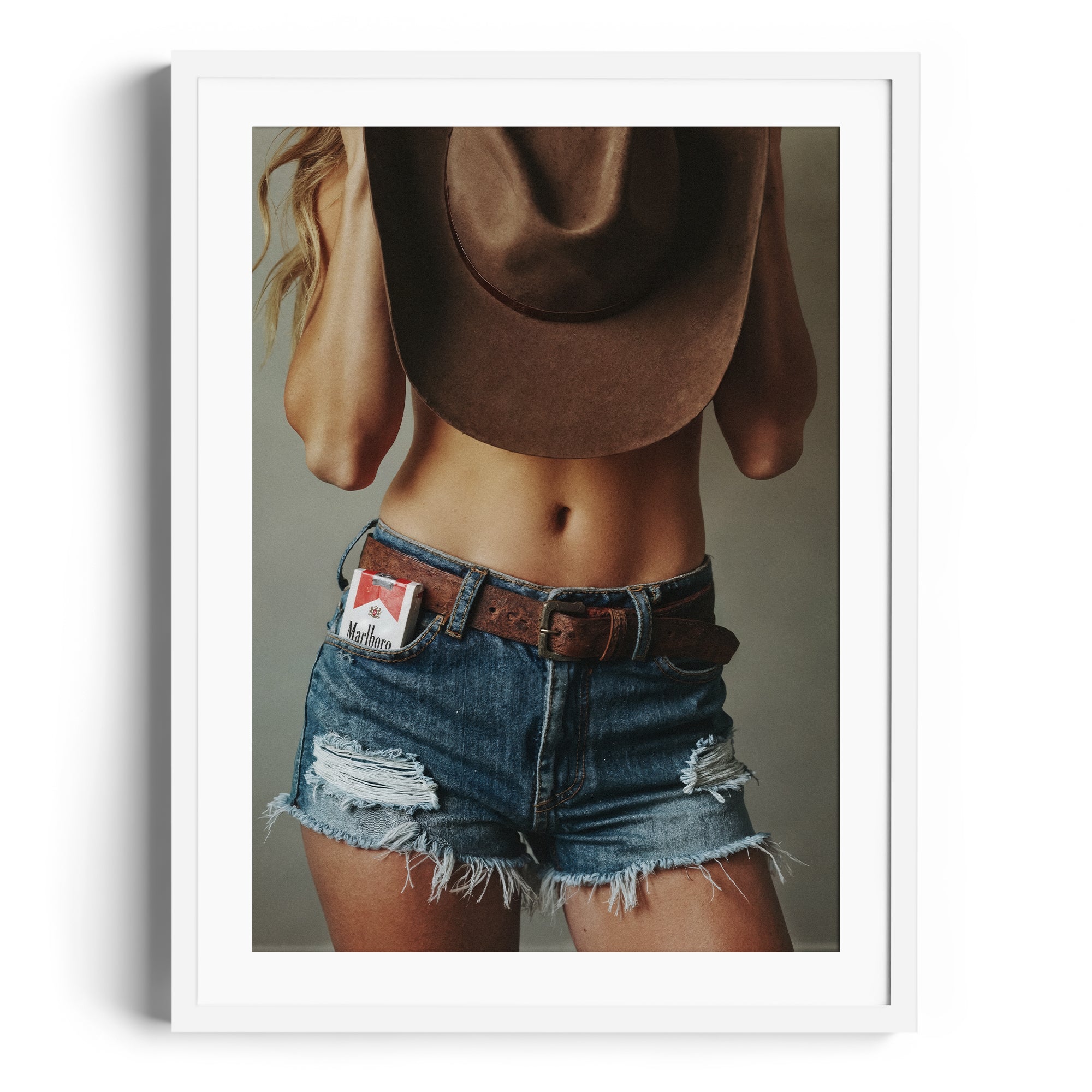 Limited edition fine art print "DIAMONT" showcasing Western allure with distressed denim and a cowboy hat. Fine art gallery Miami.