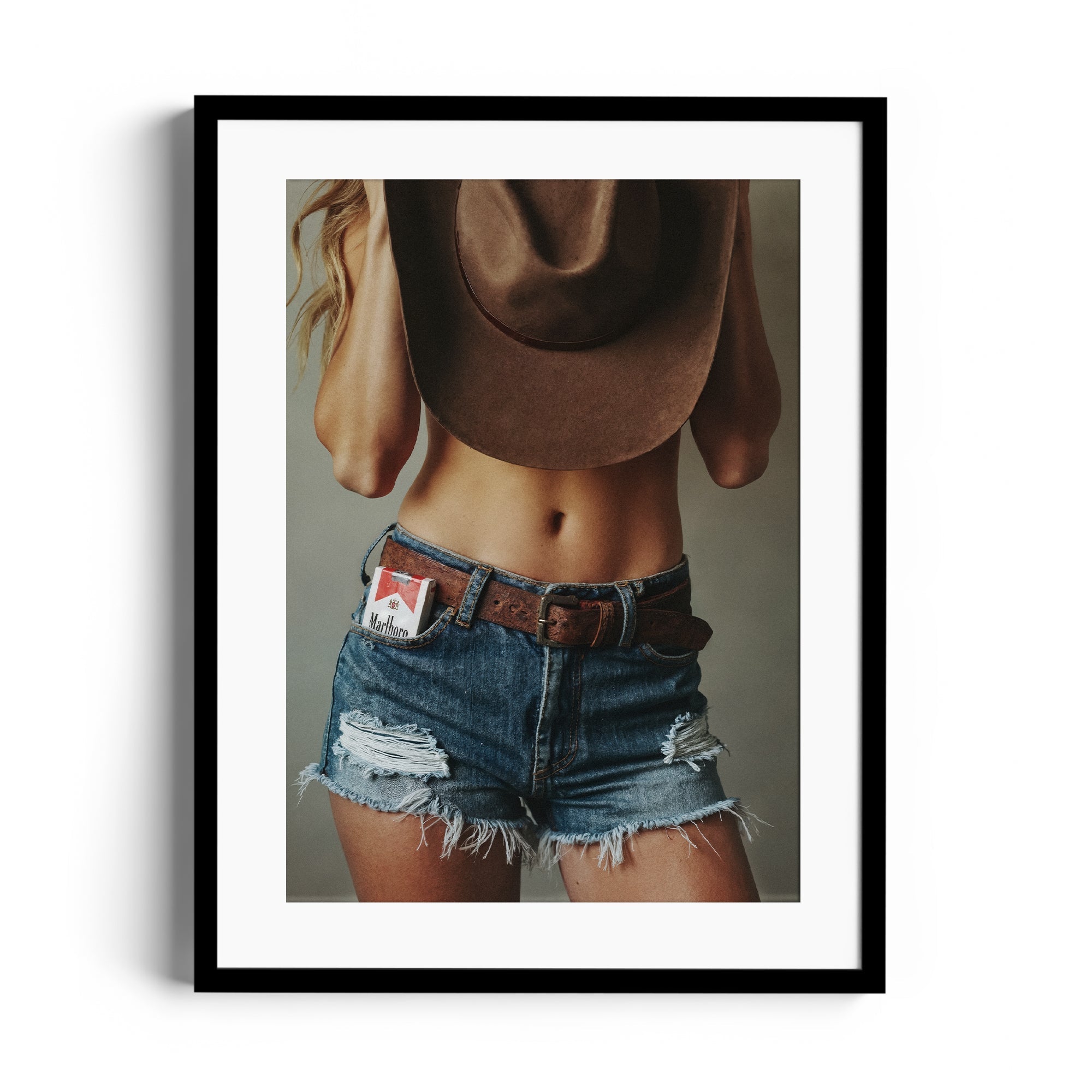 Limited edition fine art photography of a person wearing distressed denim shorts and a cowboy hat, Miami gallery print.