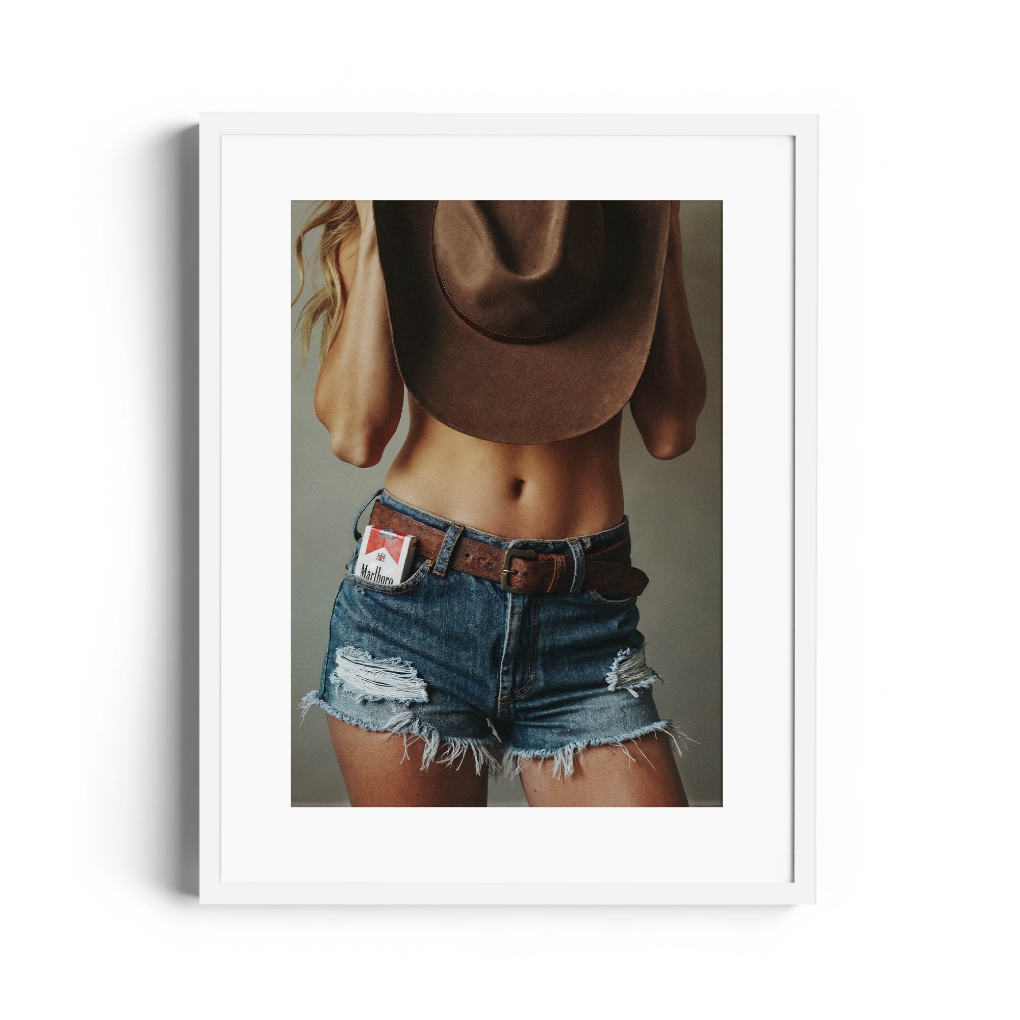 Limited edition fine art photograph "DIAMONT" featuring denim shorts and cowboy hat, showcasing Western allure in Miami gallery.
