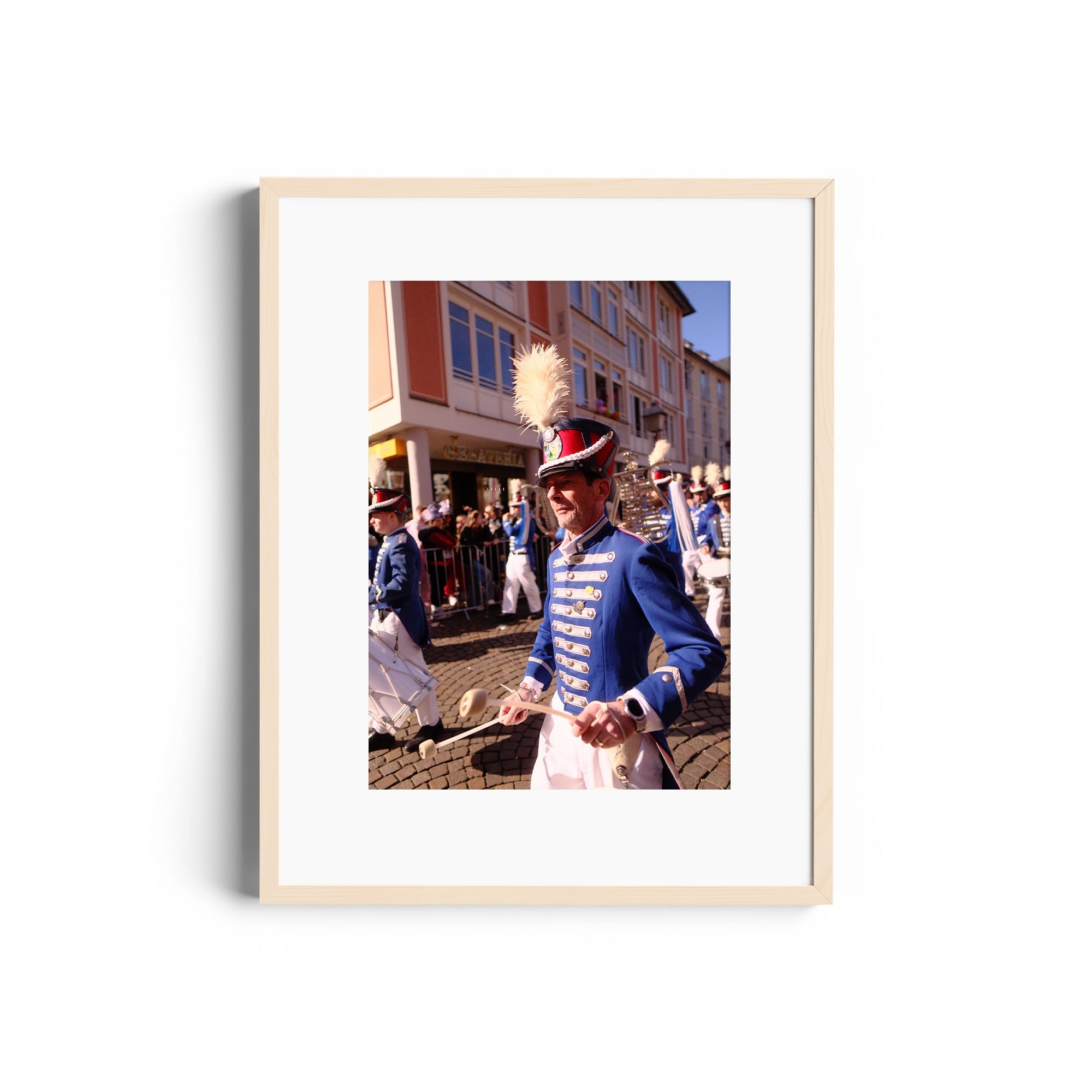 Framed fine art photography of a parade, showcasing musicians in blue uniforms at The Dana Gallery, Miami, Florida.