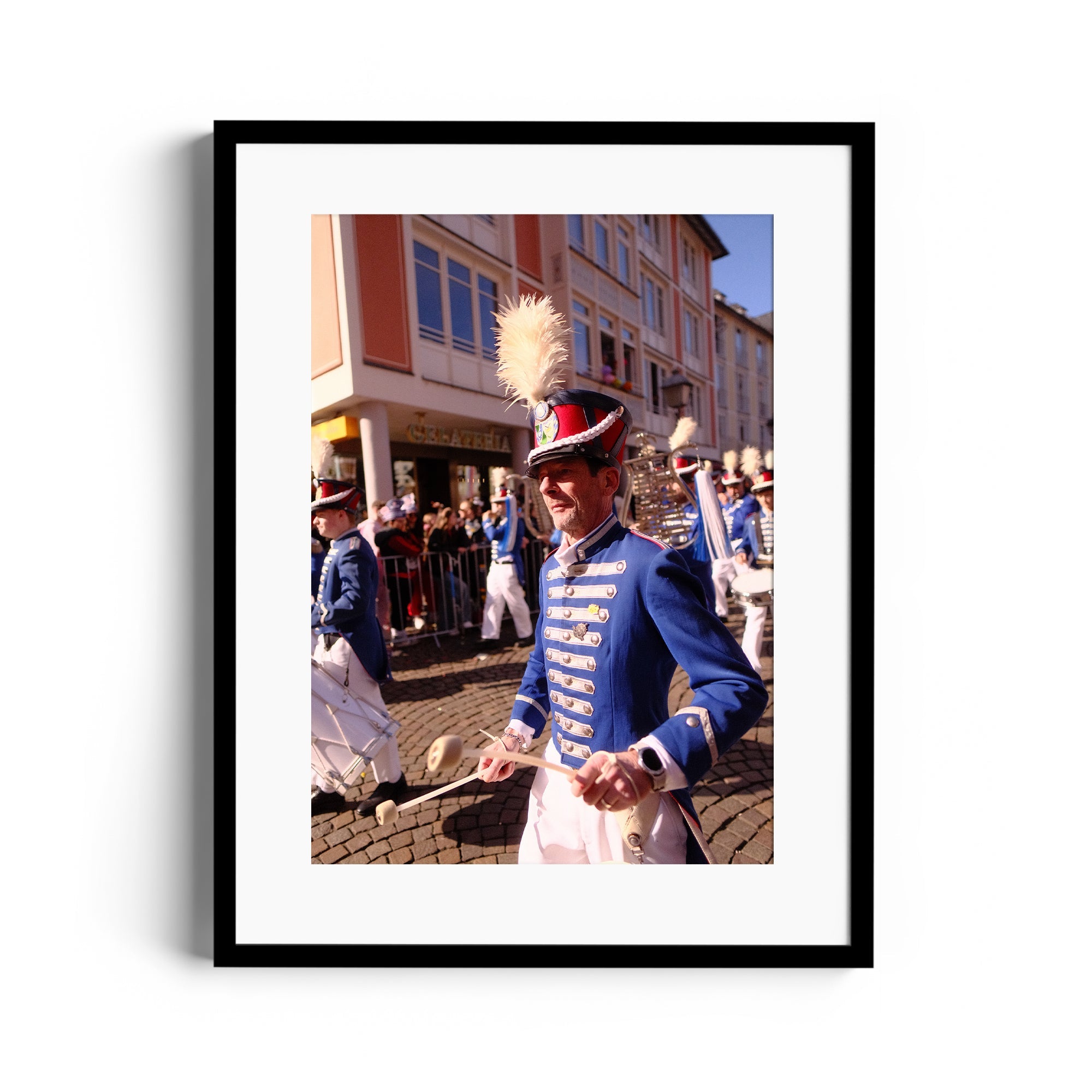 Fine art photograph of a musician in blue uniform during parade celebrations, captured by Marcelo Cadavid in Wiesbaden, Germany.