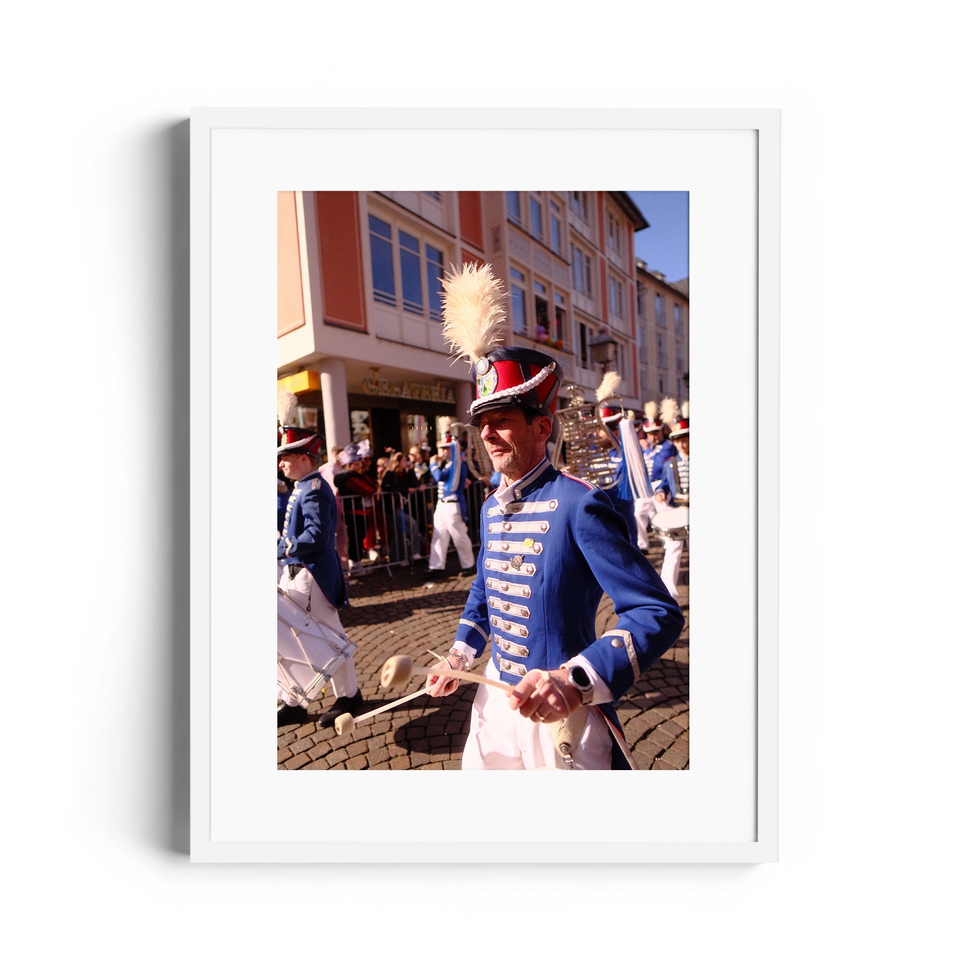 Festive parade scene featuring a musician in vibrant blue uniform, showcasing fine art photography by Marcelo Cadavid.
