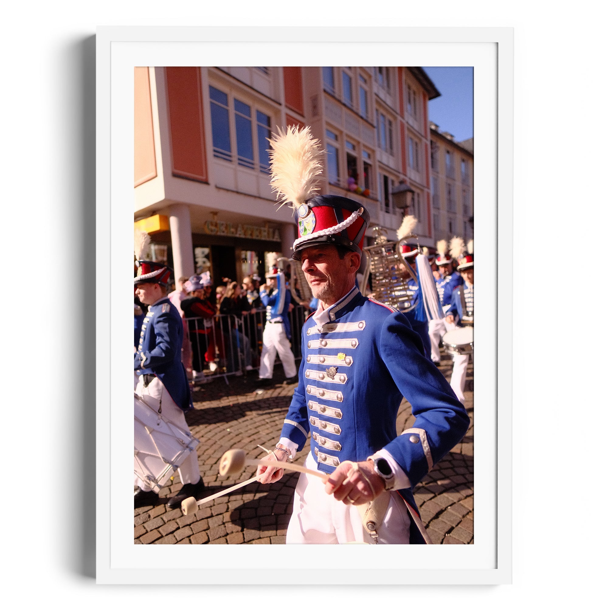 Marching band member in ornate uniform during parade, showcasing festive atmosphere in the vibrant street.