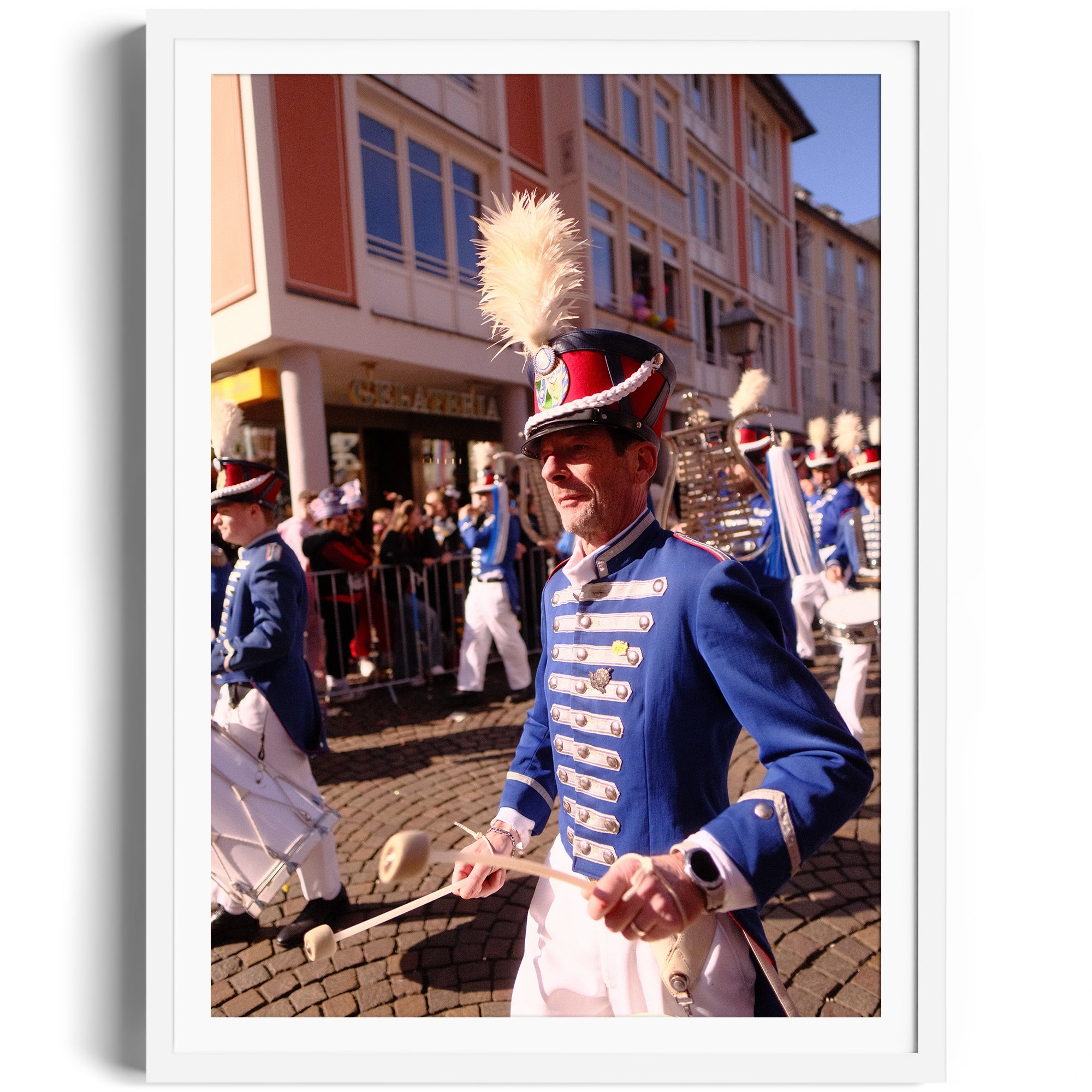 Marching band member in blue uniform performing in a parade, showcasing vibrant culture and community celebrations.