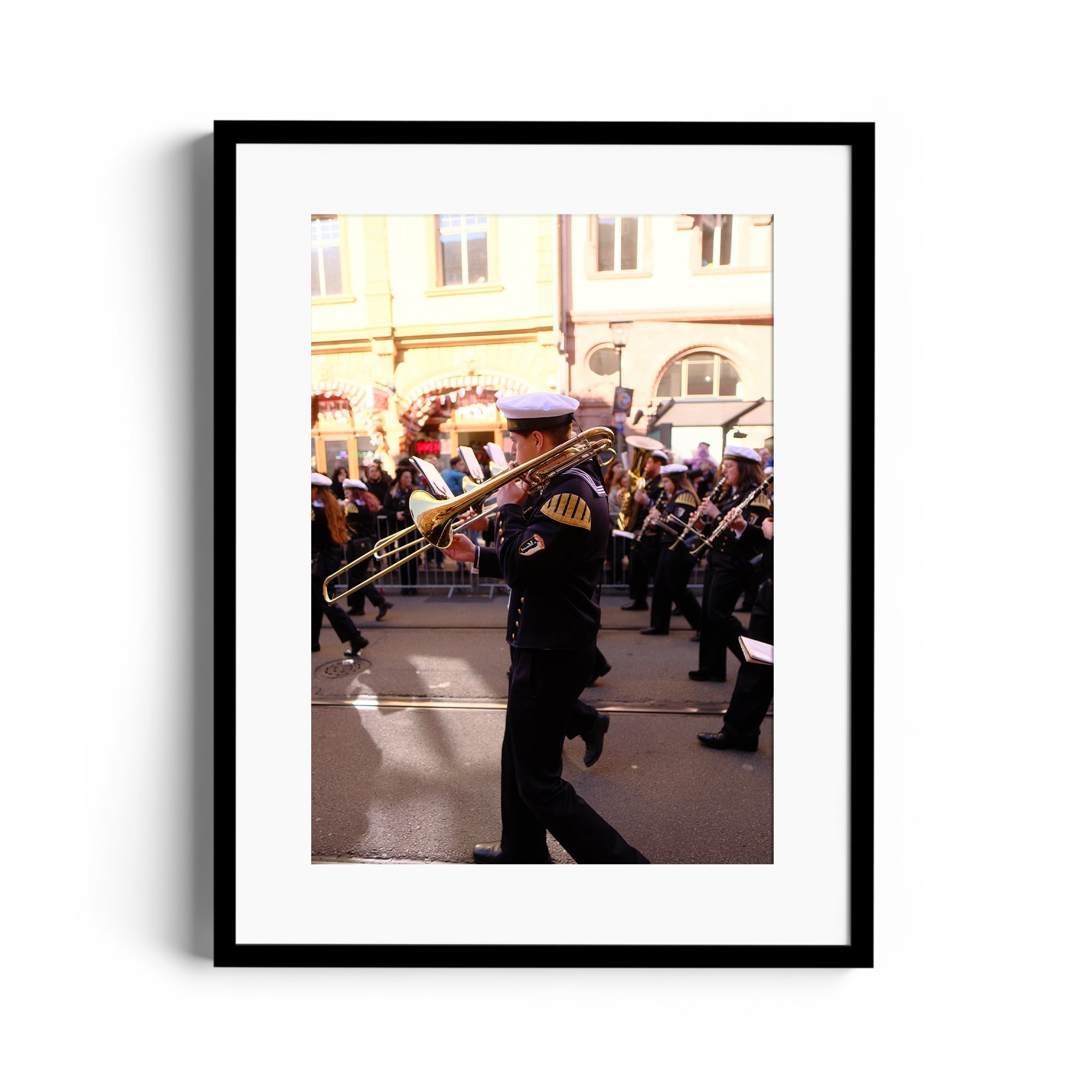 Framed fine art photograph of a musician playing trombone in a parade, by Marcelo Cadavid, available at The Dana Gallery, Miami.