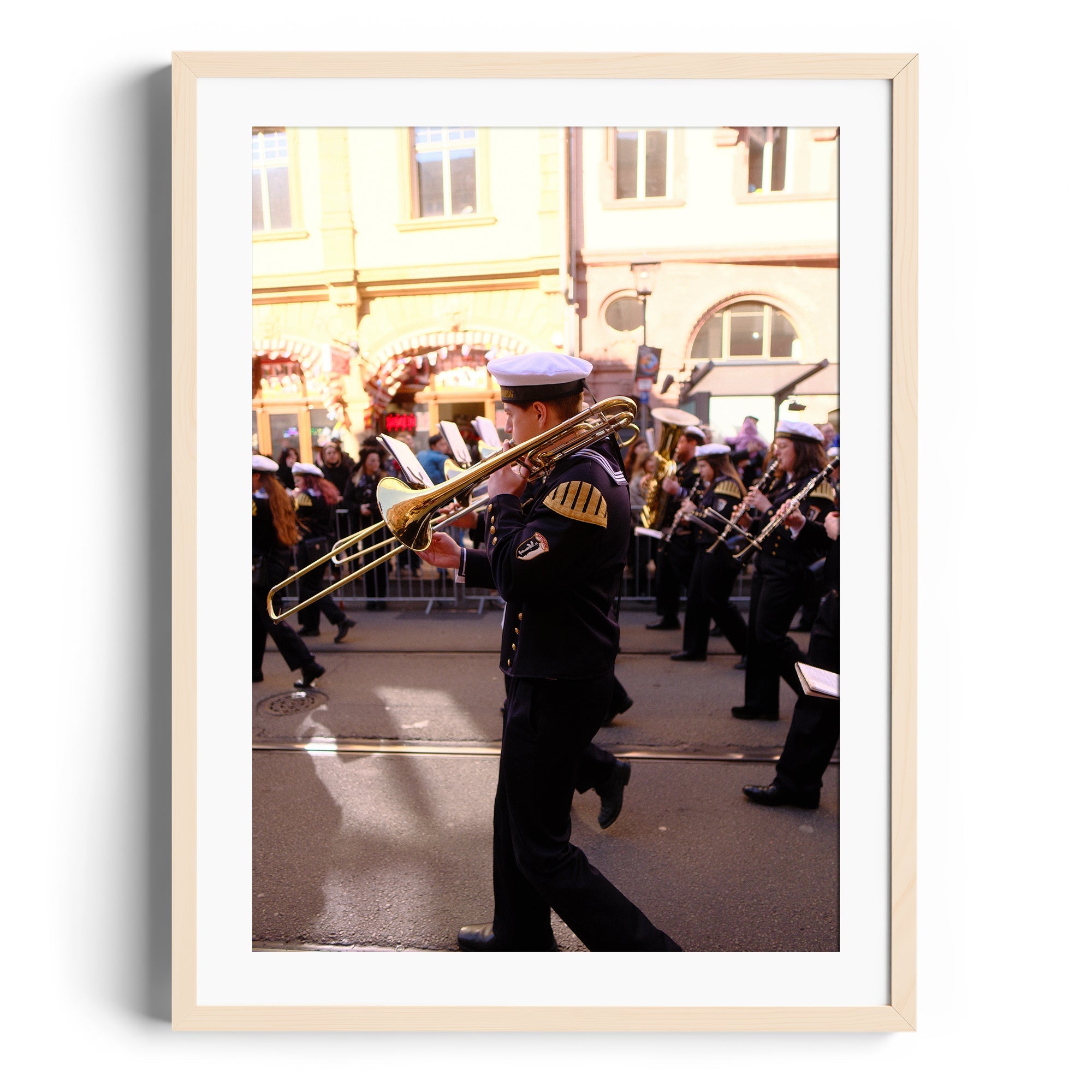 Framed fine art photograph of a trombone player in a parade, showcasing vibrant street energy.