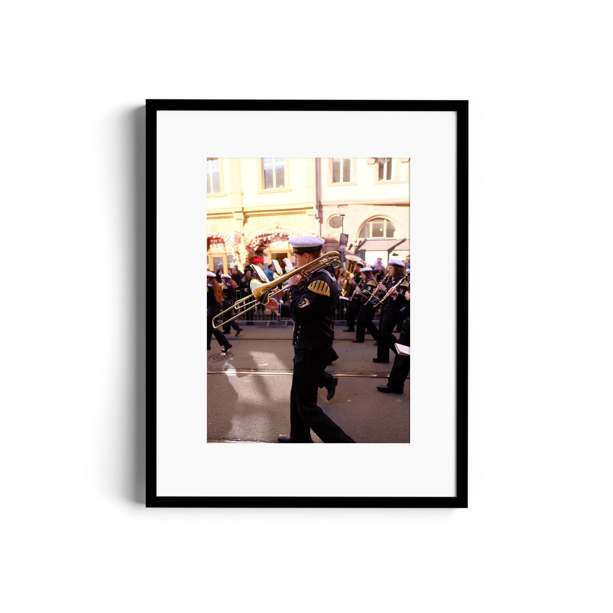 Framed fine art photograph titled 'Flow' by Marcelo Cadavid, showcasing a musician playing trombone in a parade.