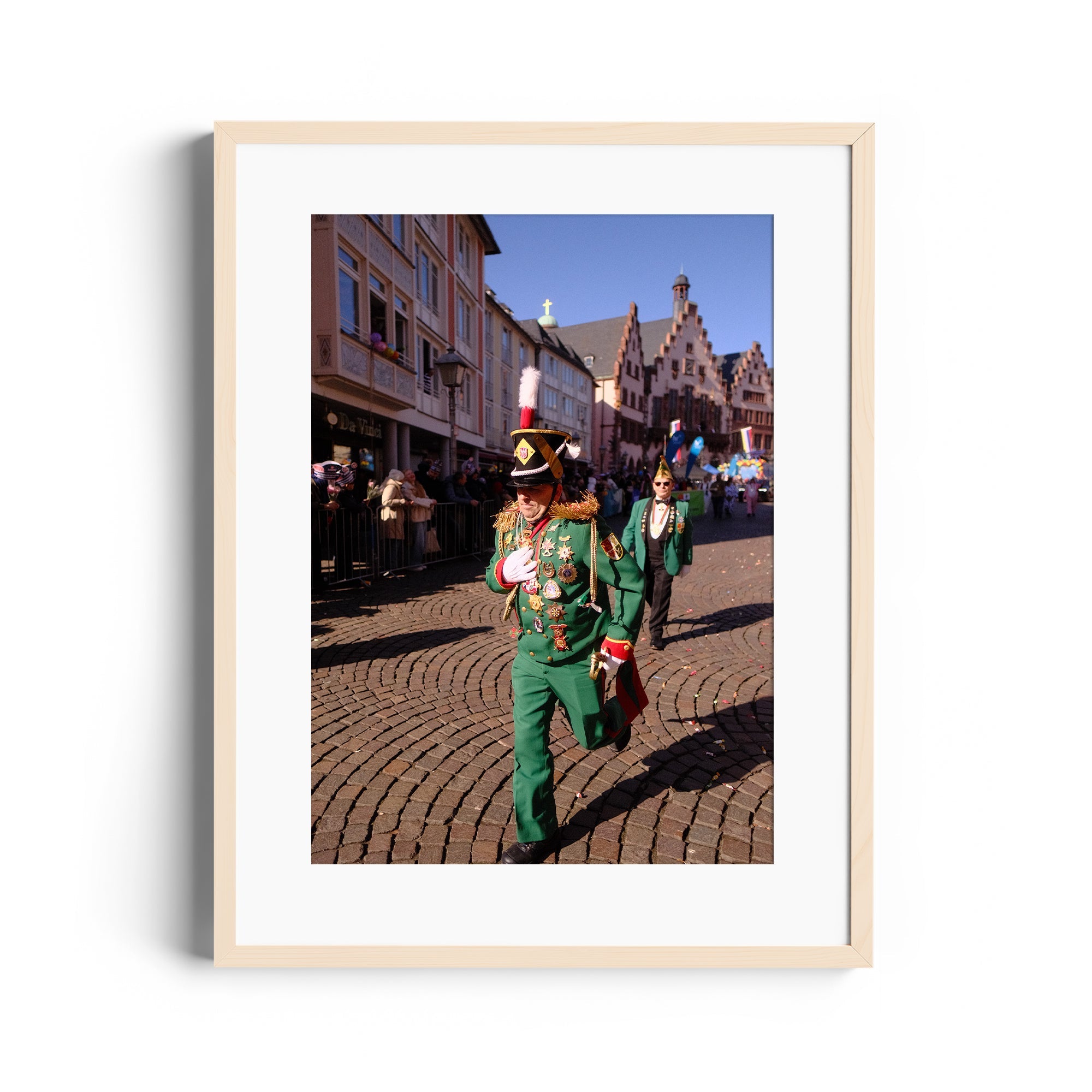 Festival parade scene in Wiesbaden, Germany, featuring revelers in green costumes celebrating with joy.