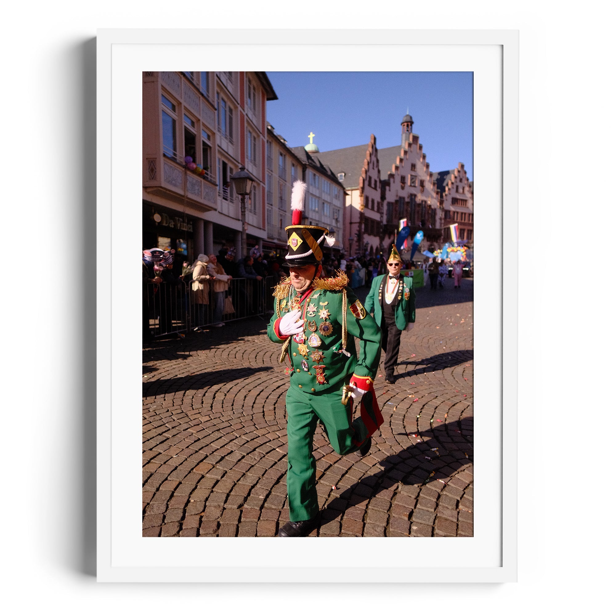 Framed fine art print of a festive parade in Wiesbaden, featuring a soldier in green attire at THE DANA GALLERY, Miami Florida.