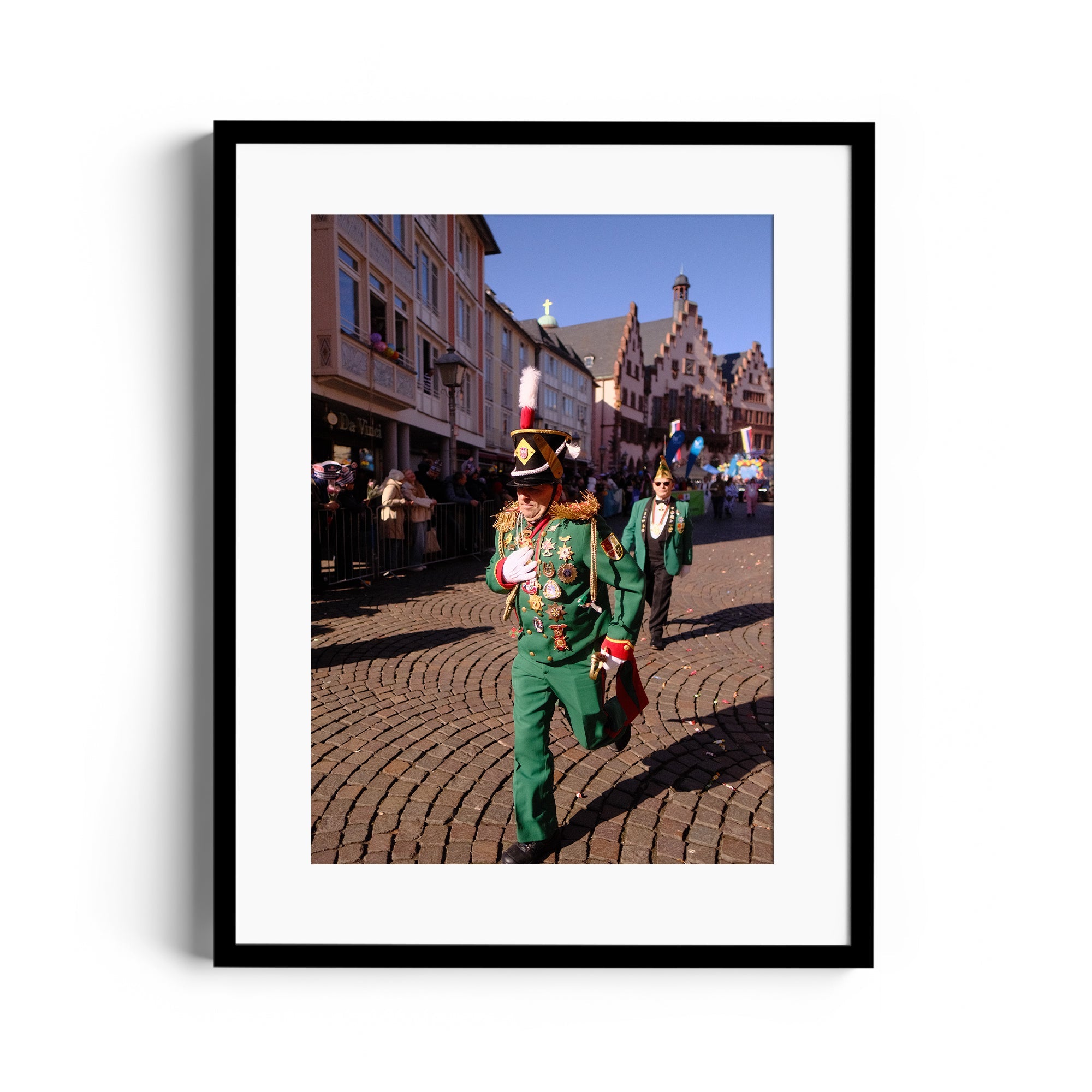 Carnival parade scene featuring two performers in green costumes, capturing vibrant moments of celebration.