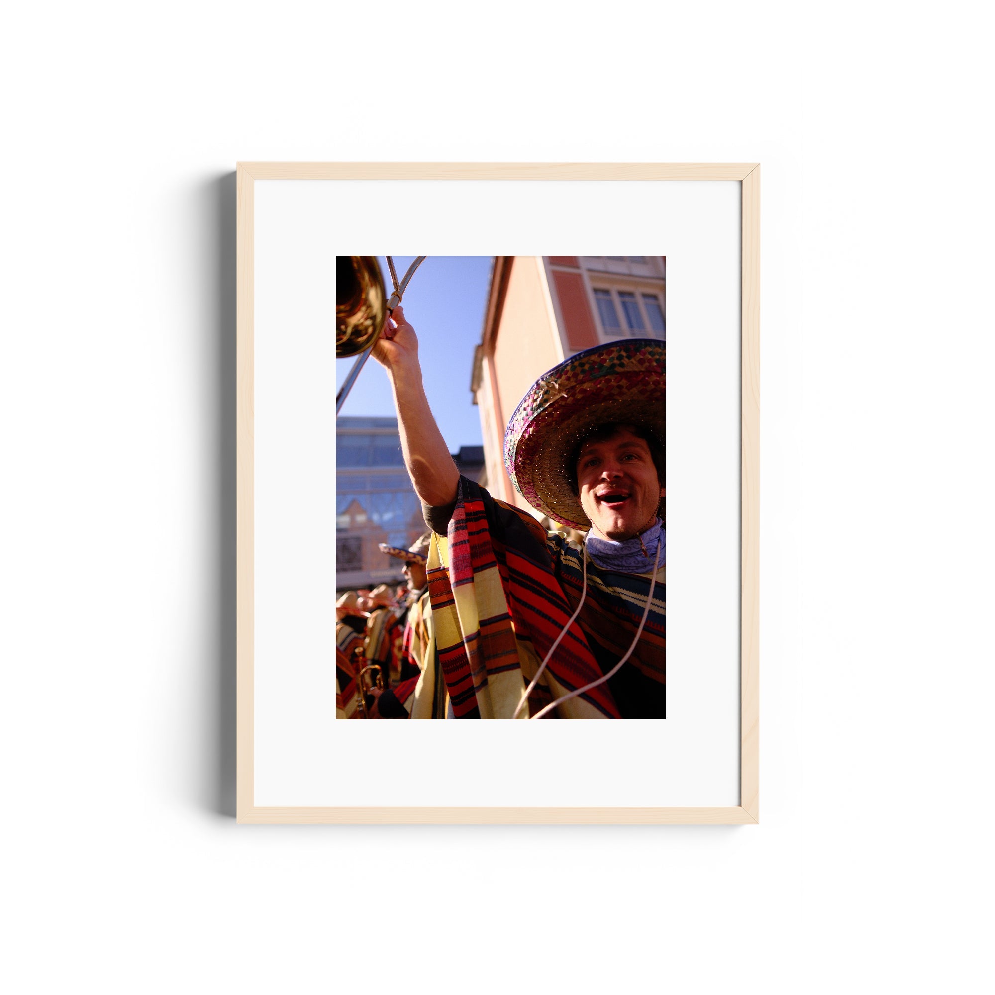 Framed image of a joyful mariachi musician in vibrant attire, showcasing fine art photography by Marcelo Cadavid, available at The Dana Gallery.