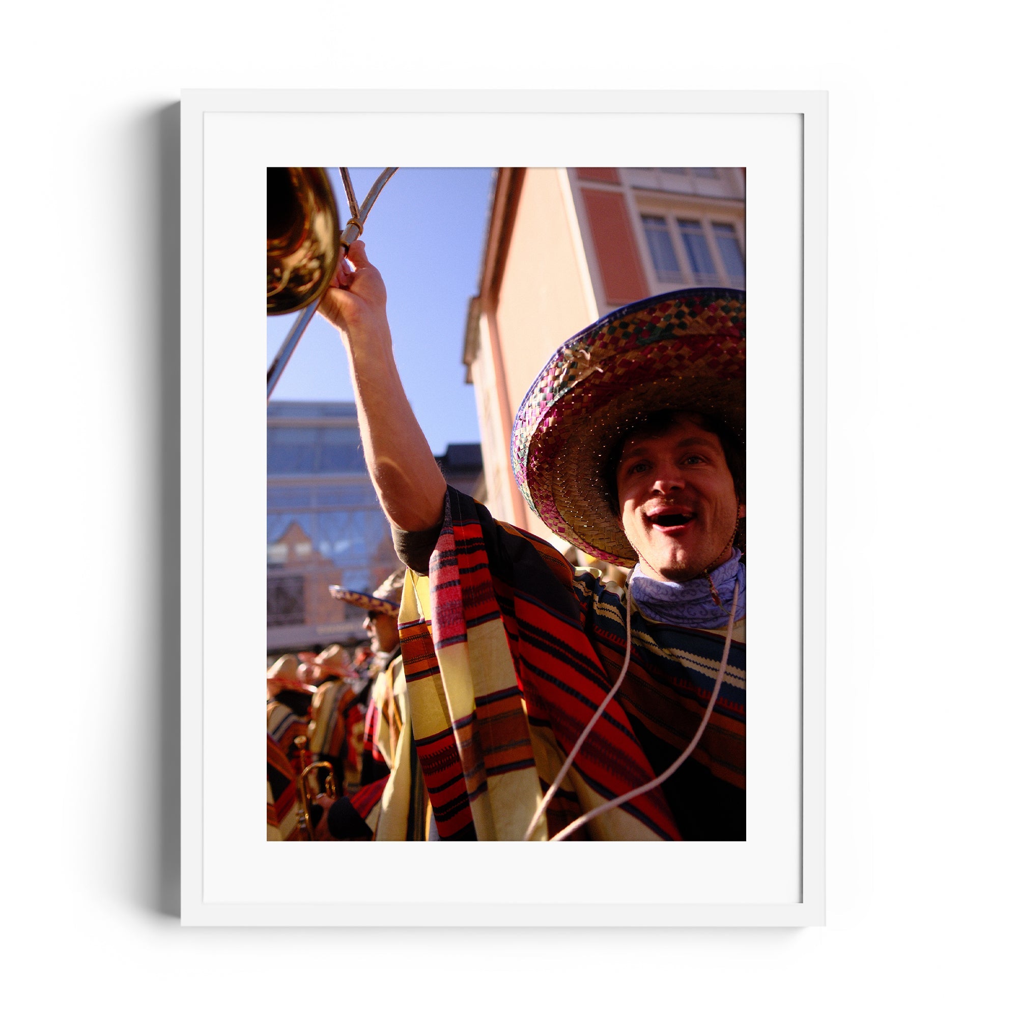 Framed fine art photograph of a joyful mariachi musician celebrating at a festive event.