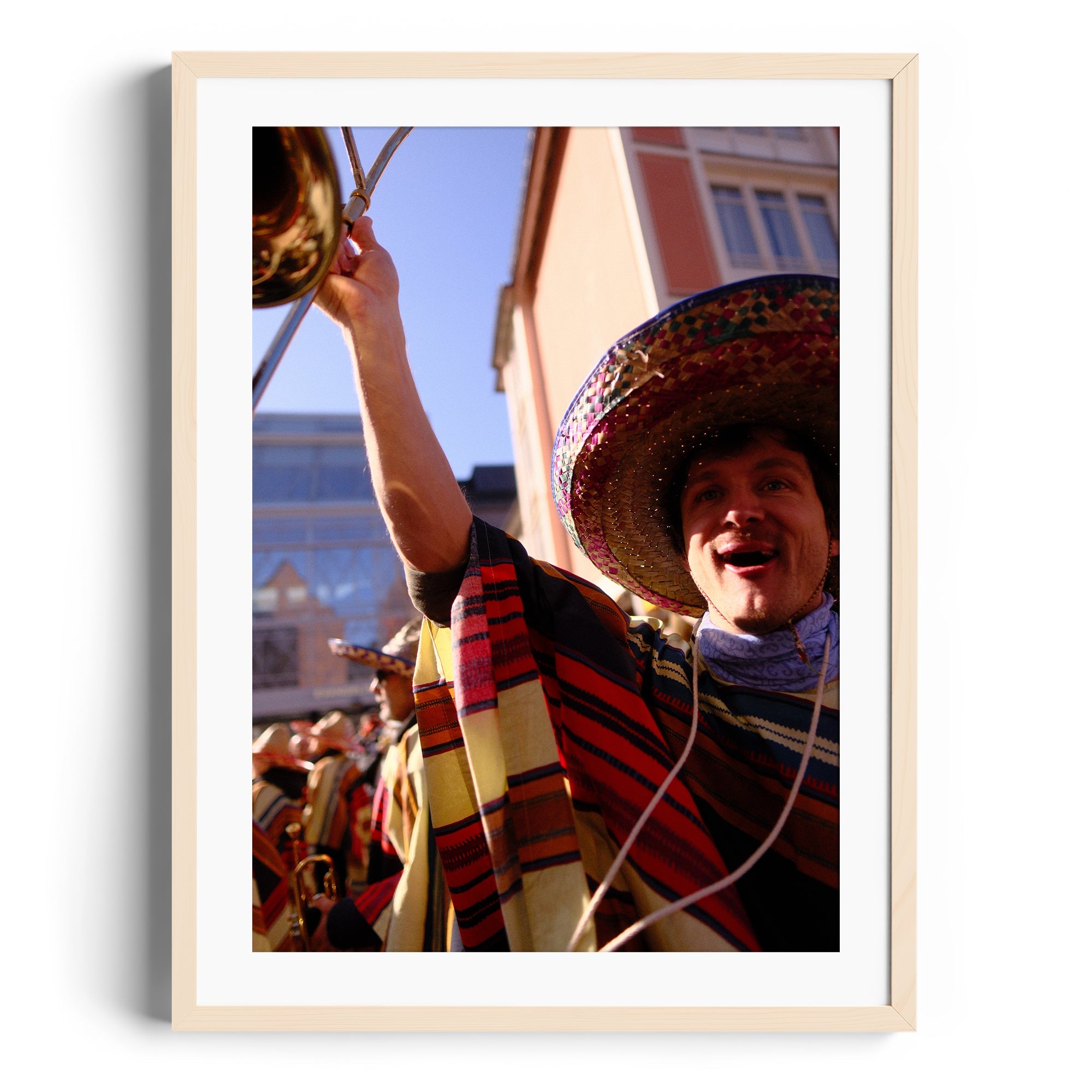 Framed fine art photograph of a musician celebrating in a colorful poncho at a mariachi event, from The Dana Gallery, Miami.