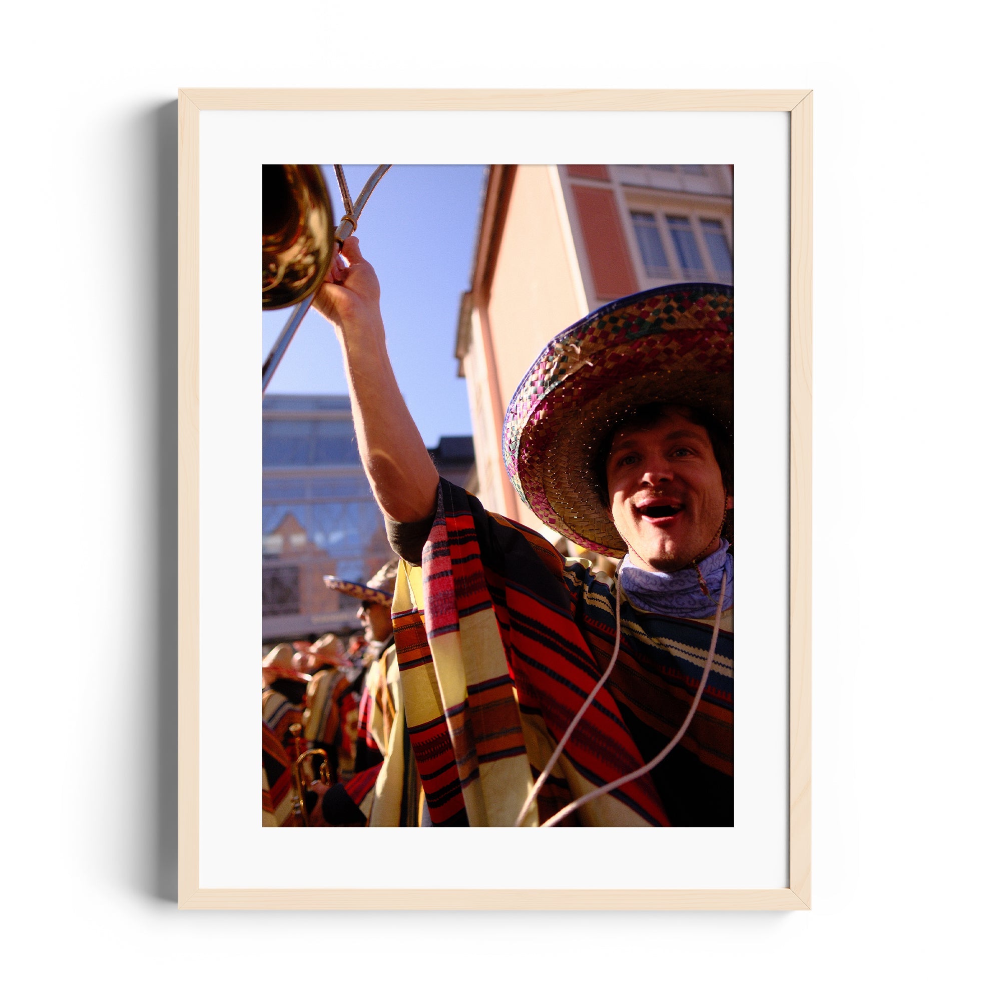 Smiling musician in traditional attire celebrating at a mariachi festival, framed fine art photography by Marcelo Cadavid.