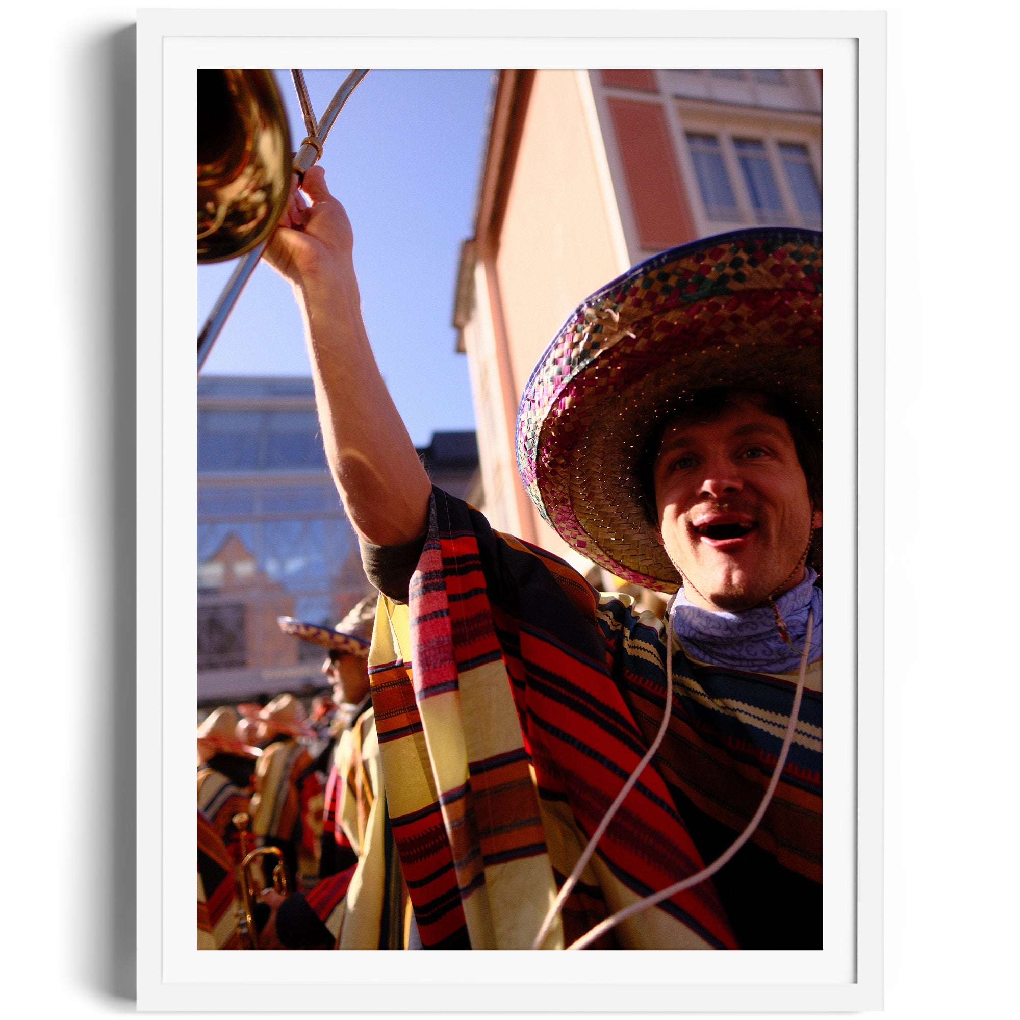 Vibrant performance image of a mariachi musician celebrating with a brass instrument, captured in fine art photography.