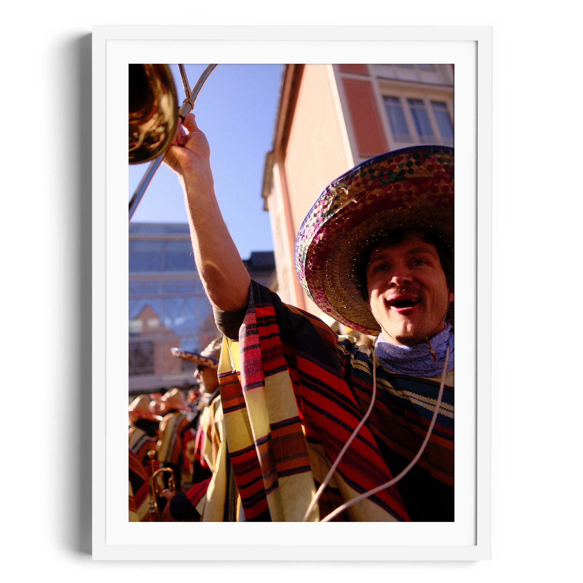 Vibrant mariachi musician in colorful attire playing trumpet at a celebration, captured by Marcelo Cadavid, fine art photography.