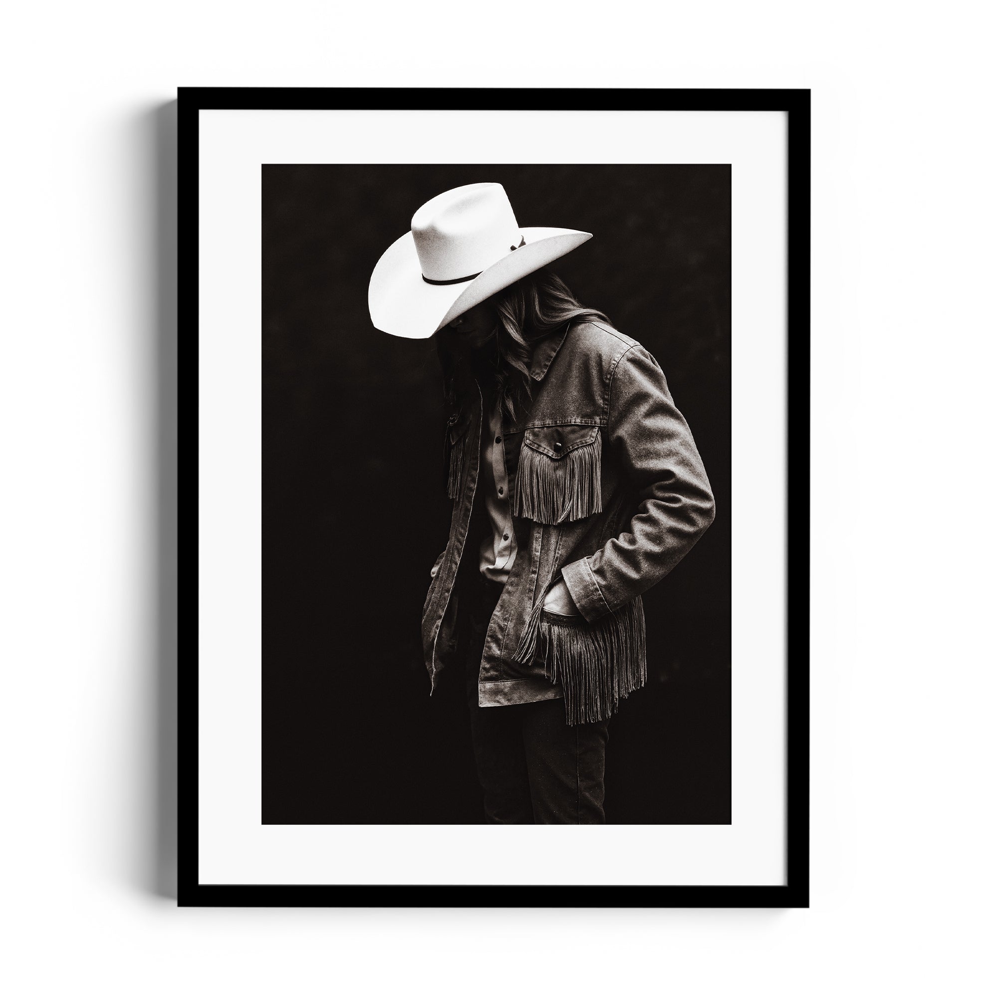 Monochromatic fine art print of a figure in a fringed denim jacket and cowboy hat, showcasing Western spirit. Print fine art gallery Miami.
