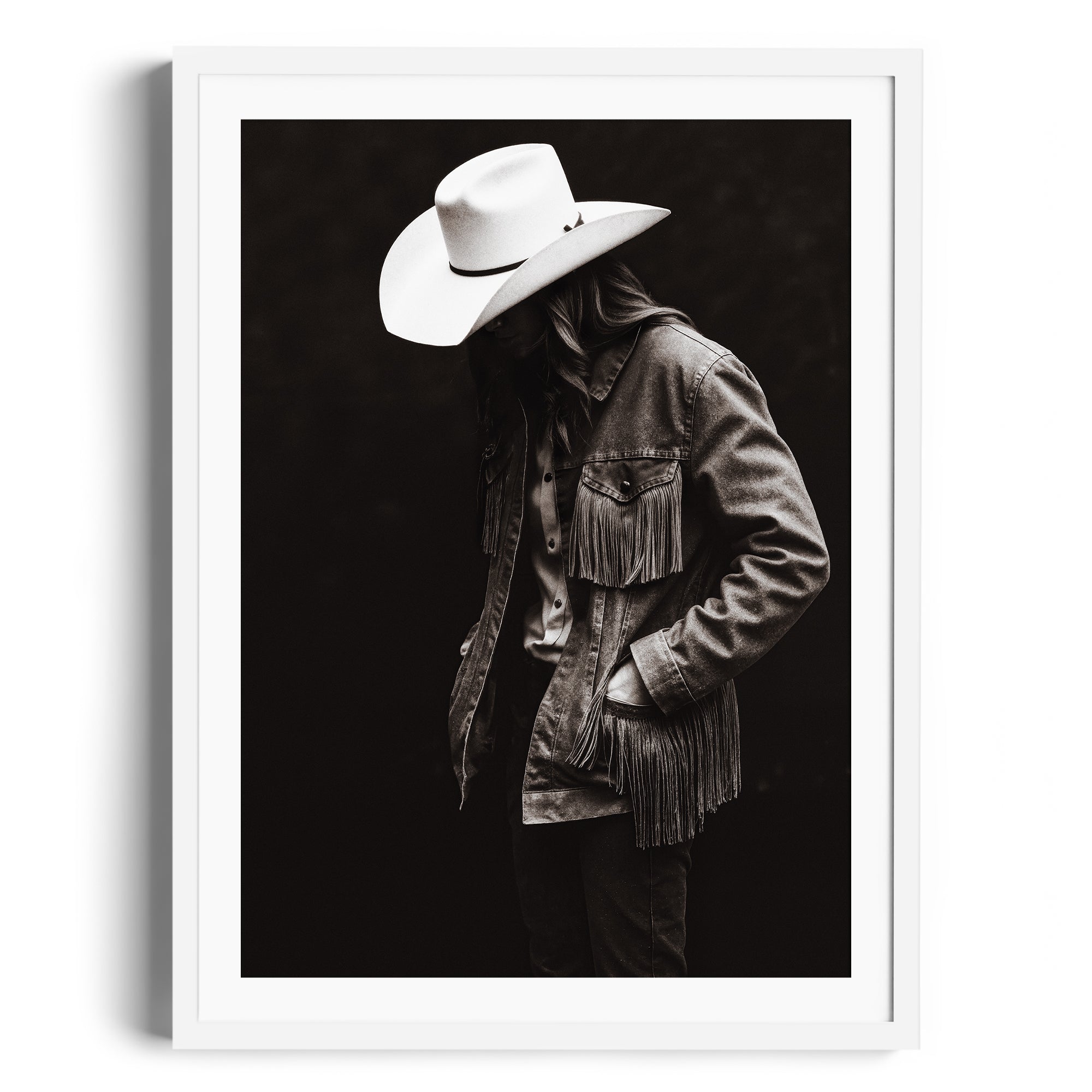 Monochromatic fine art photograph of a figure in fringed jacket and cowboy hat, representing Western spirit in Miami gallery.