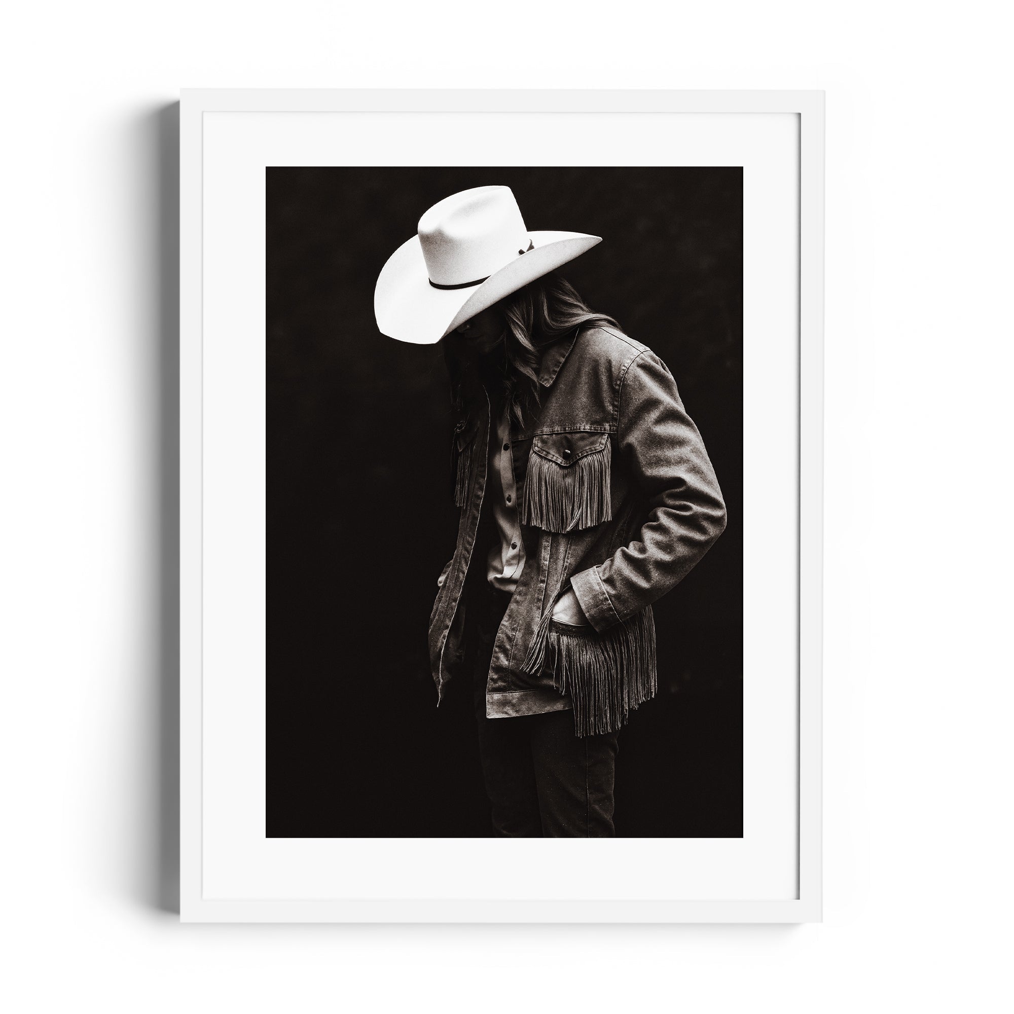 Monochromatic fine art print featuring a lone figure in a fringed jacket and cowboy hat, reflecting Western spirit in Miami gallery.