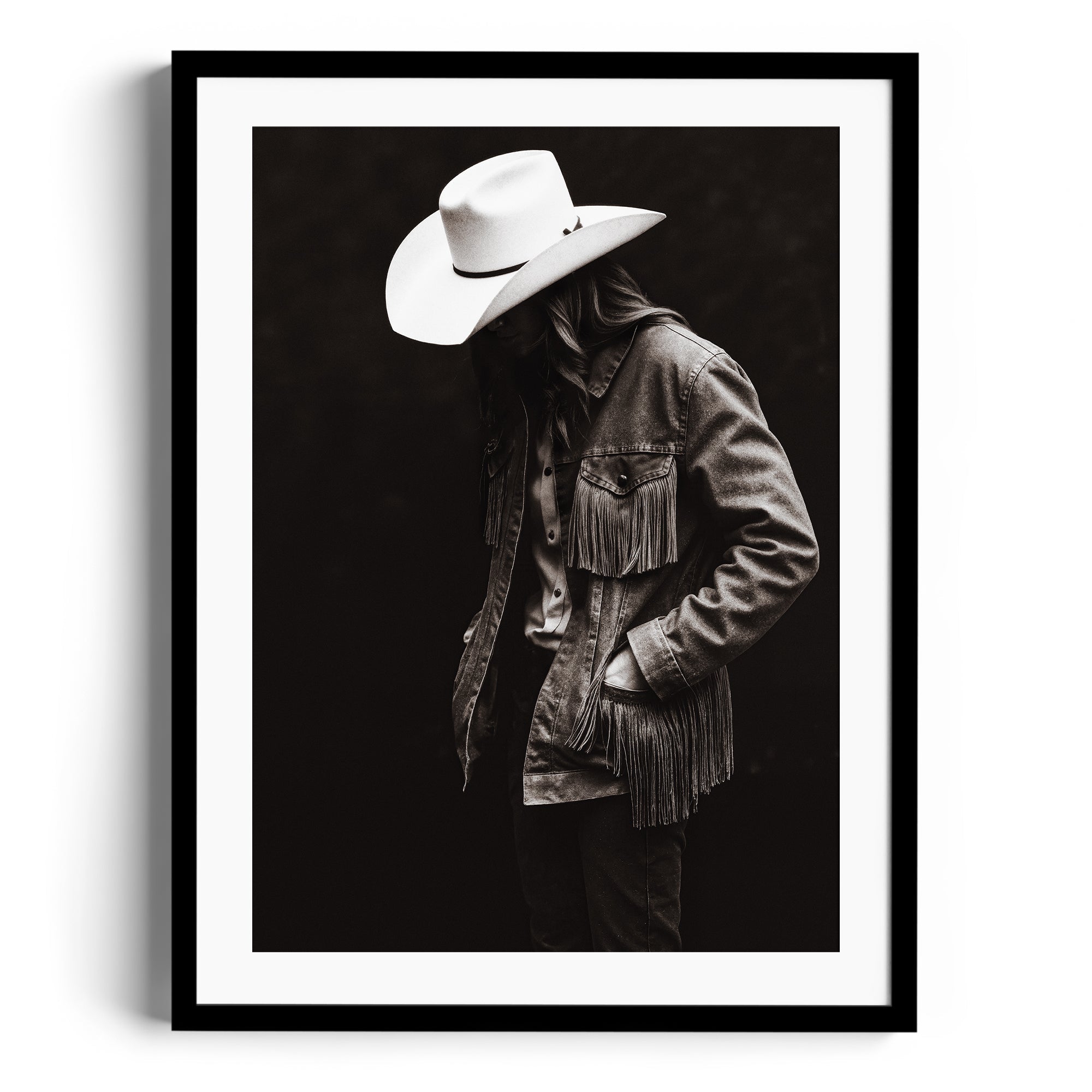 Monochromatic fine art print of a figure in a fringed denim jacket and cowboy hat, showcasing rugged independence. Fine art gallery Miami.