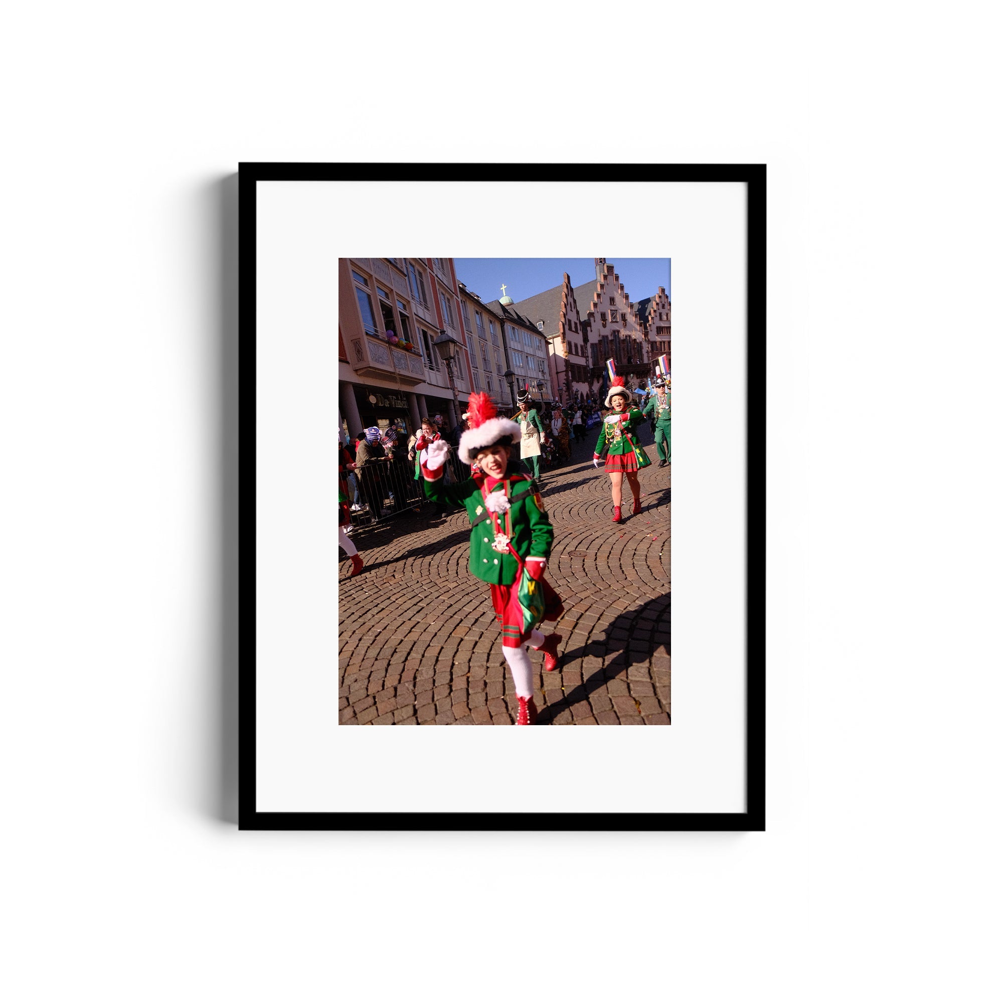 Framed fine art photograph of a festive parade featuring colorful costumes in a quaint town square.