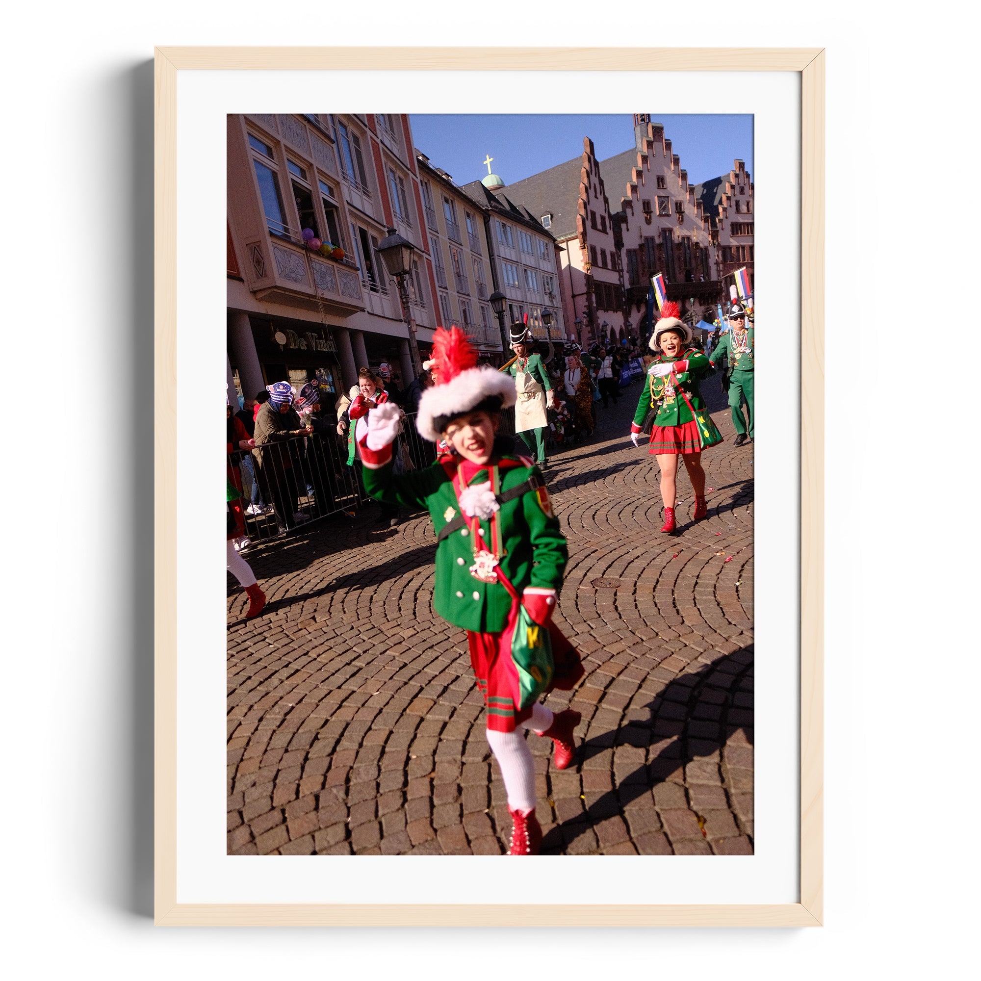 Colorful holiday parade featuring children in festive costumes on a cobblestone street.