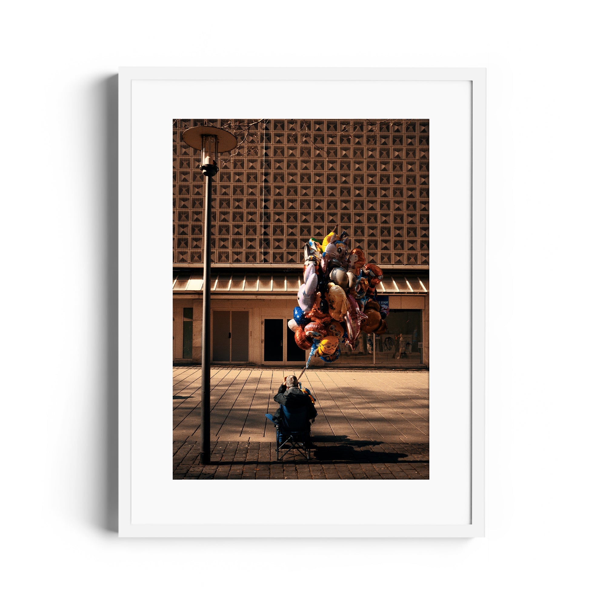 Framed fine art photography by Marcelo Cadavid, showcasing a balloon seller in urban Miami, highlighting elegance.
